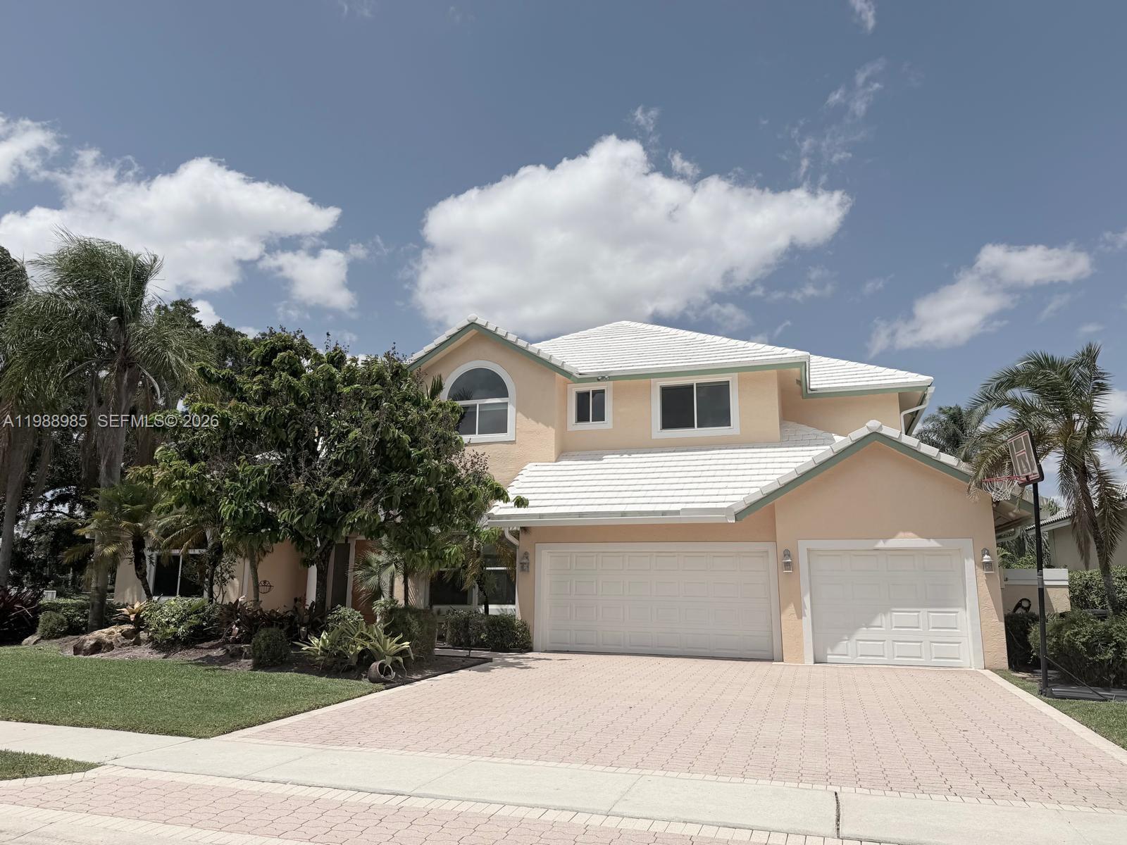Experience luxury living in this stunning builder’s model home located in the exclusive gated community of Plantation Palms. This per appraiser, 4700+ Sq.Ft. is perfectly positioned on a premium lakefront lot, this upgraded residence offers breathtaking panoramic water views and exceptional indoor-outdoor living. Inside, find elegant porcelain tile flooring on the main level and rich solid wood flooring upstairs(second-floor updated wood flooring complemented by custom interior doors and a striking marble wood-burning fireplace with a stylish bar, ideal for entertaining. The fully remodeled kitchen features custom cabinetry, sleek Silestone countertops, and high-end stainless steel appliances. Designed for comfort, convenience, and peace of mind, the home includes all hurricane impact windows and doors, a full standby generator, and integrated wiring for surround sound and a home theater system. Bright enclosed spaces provide flexible options for a home office, playroom, or den. The luxurious primary suite boasts a private dressing area, custom walk-in closet, and a spa-inspired bathroom retreat. Step outside to your own private oasis with a fenced yard, expansive patio, motorized XL awning, heated saltwater pool, and lush landscaping—all overlooking serene lake views. Additional highlights include a roof just 2 years old and a first-floor A/C replaced 4 years ago. This exceptional home offers the perfect blend of elegance, functionality, and the ultimate Florida lifestyle. A true must-see!
