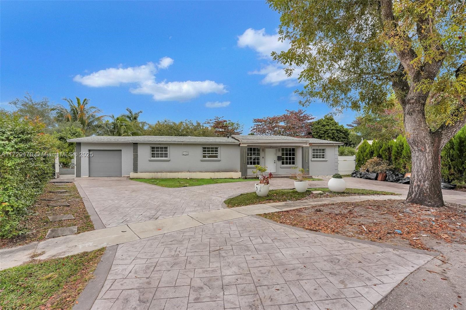 Discover this expansive retreat, a unique gem brimming with potential. Set on a sprawling corner lot, this 7-bedroom, 5.5-bathroom home offers unmatched versatility and endless possibilities. With a spacious layout featuring multiple living areas, and a standalone studio, it’s ideal for multi-generational living, hosting, or generating rental income. The large backyard is a private oasis with a pool, outdoor workout area, and plenty of space to customize or expand. Conveniently located just moments from I-95, this property is perfect for living, entertaining, or investing. Don’t miss this rare opportunity!