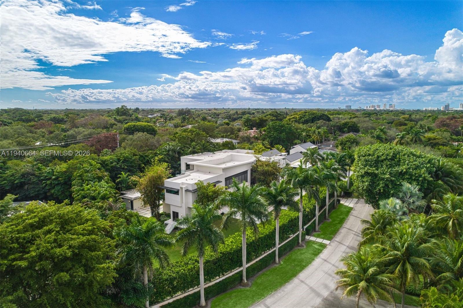 Designed by renowned architect Alberto Cordovez, this extraordinary Ponce Davis estate delivers nearly 10,000 SF under air on an expansive 45,302 SF lot. Featuring 7 bedrooms, 8 full baths, and 1 half bath, the residence blends striking modern architecture with resort-style living. A private gated drive leads to an oversized driveway and a 3-car garage with space for 3 additional car lifts, surrounded by lush tropical landscaping featuring bamboo and foxtail trees. Interiors showcase soaring ceilings, limestone and hardwood floors, fluted walls, integrated architectural ceiling system, custom Italian doors, elevator, Crestron automation, private movie theater, full gym, and multiple family and entertaining spaces—all bedrooms overlooking the pool. The chef’s Mia Cucina kitchen is equipped with Wolf and Sub-Zero appliances, double ovens, steam oven, wine room, and oversized island. Outdoors, enjoy covered terraces, summer kitchen, cabana, and a 20’ x 40’ saltwater infinity pool with spa and waterfall. A full-house generator, a full house water filtration system, advanced security, and premium systems complete this one-of-a-kind modern retreat.