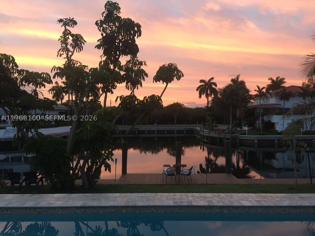 This beautiful house sits on an elevated lot in prestigious Gables by the sea. A gated community with a "voluntary HOA fee". It features modern finishes, an updated kitchen w/ quartz countertop, 4 spacious bedrooms (2 en-suites), a home theater/den that can double as a 5th bedroom, and 3.5 bathrooms. Enjoy the safety and tranquility provided by impact windows and doors, covered outdoor area, a large 2 car garage and more. The private designer dock and seawall offer the perfect spot to witness breathtaking sunrises and sunsets. As night falls, the underwater lighting turns your dock into a mesmerizing display, showcasing the marine life and creating the ambiance of your own personal aquarium. Located near top-rated A+ schools. **(This house is on  sewer, not septic system and it qualifies for Pinecrest elementary school)**. Contact owner/agent for showings. *No ocean access*