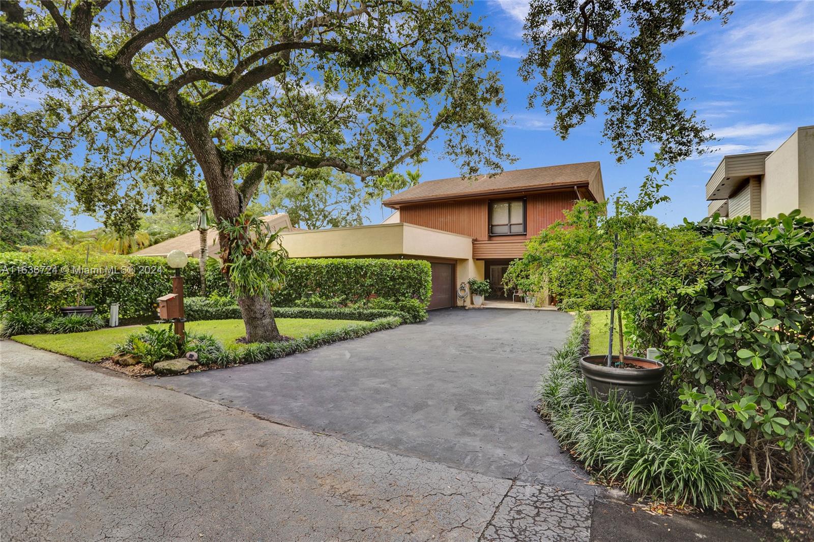 Now is the chance to own a rarely available coveted model in the exclusive Hidden Oaks community. With just 71 homes, this serene tree-lined enclave offers a 24-hour guard and privacy walls. Conveniently close to shops, hospitals and major highways.  Main floor has a spacious primary suite with ultimate privacy along with ensuite 2-room bathroom. Upstairs you'll find additional bedrooms separated by a Jack & Jill bathroom. The open floor plan allows for easy entertaining, Cathedral ceilings and striking stacked stone fireplace create an impressive and inviting atmosphere. The gourmet eat-in kitchen is a chef's delight. Step outside to enjoy a beautifully landscaped pool area and central atrium with all  rooms opening to this serene space. 2 car garage & full attic ensure plenty of storage.