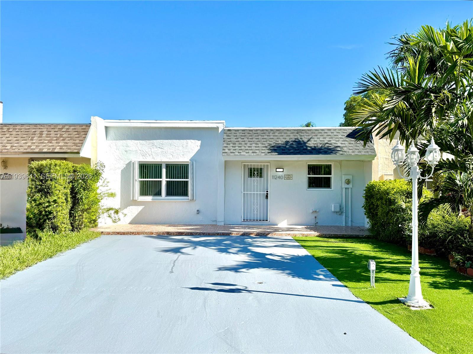 New Roof 2025 & Impact Windows Throughout! Beautifully updated 2-bedroom, 2-bath villa with an extremely low HOA and a large, fully enclosed private backyard, offering rare privacy and flexibility. Commercial vehicles are allowed, and the spacious driveway provides added convenience. This move-in-ready home features porcelain tile throughout, spacious bedrooms, and a bright, open layout. The modern kitchen is designed for both style and function, with white cabinetry, a large center island, Calacatta quartz countertops, and new stainless steel appliances. Both bathrooms include walk-in showers, and the home is complete with a new washer and dryer. Ideally located near shopping, dining, and major roadways, this villa combines comfort, upgrades, and versatility