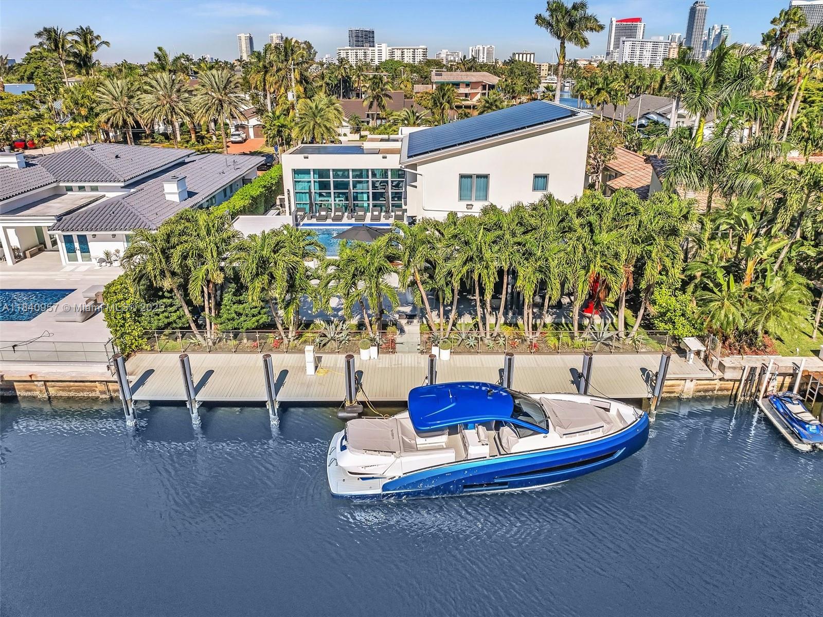 Experience the ultimate waterfront lifestyle in this contemporary estate in the guard-gated Golden Isles. This move-in-ready home features a sleek, modern design with abundant natural light and high-end finishes. The open layout includes spacious living, dining, and family areas, plus a chef-style kitchen with water views. Upstairs, the private master suite offers a spa-inspired bath, sitting area, and balcony. Enjoy the outdoors with a resort-style heated pool, summer kitchen, and large patio. Boaters will love the 85 feet of deep-water frontage, full-service dock, no fixed bridges, and no wake zone. A rare home in one of South Florida’s most desirable waterfront communities.