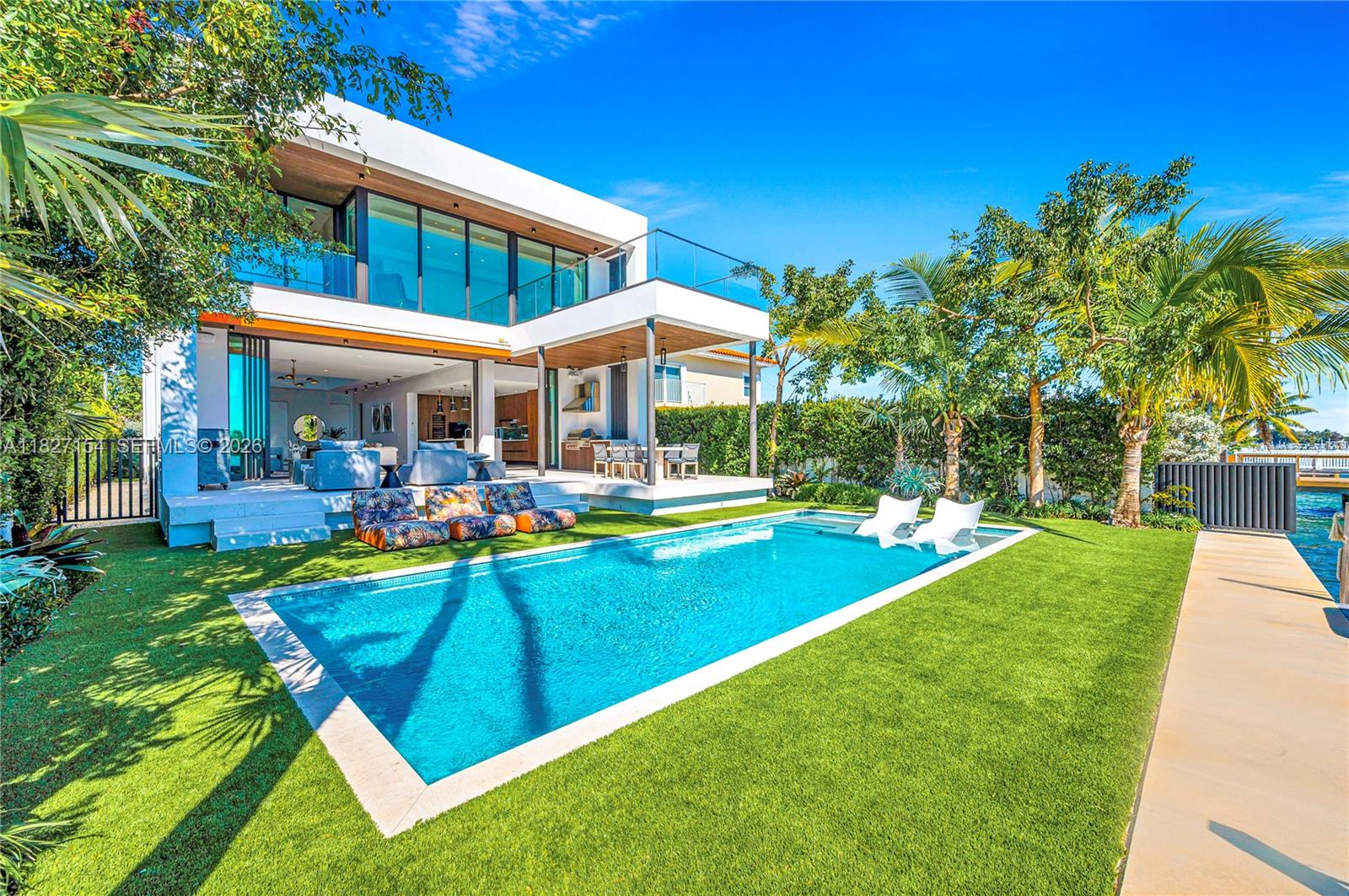 Experience luxury waterfront living in Miami Beach. This recently built modern home offers breathtaking Biscayne Bay views, spectacular sunsets, and 50 feet of waterfrontage with no fixed bridges to the ocean. Featuring 4 spacious bedrooms and 4.5 bathrooms, it spans nearly 4,000 sqft under A/C, plus a climate-controlled garage that can accommodate a car lift, and a boat dock.
Designed with sleek modern architecture and meticulous attention to detail, the home includes a fully integrated Savant smart home control system, mosquito misting system, and premium finishes throughout. Located in a gated community, within walking distance to the beach and close to top-rated schools, this residence offers the perfect blend of luxury, comfort, and convenience.