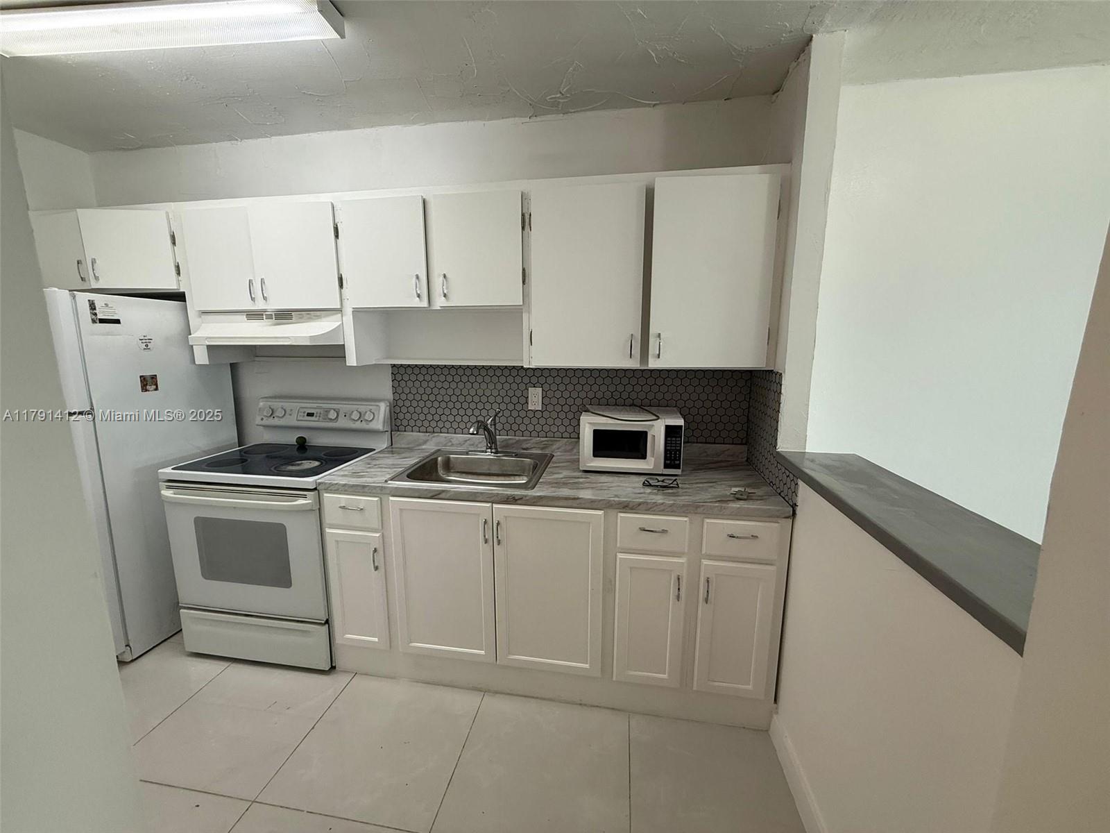 NEW PAINT & RENOVATED KITCHEN. Experience the best of Miami living in this charming FIRST FLOOR two-bedroom, two-bathroom apartment. Featuring tile floors throughout with a beautiful back porch facing the serene water views. Just minutes away from the Miami International Airport, Coral Cables & Downtown. Walking distance to nearby resturants and shopping. Laundry room located on same floor. You won't find a unit at this price on the first floor in this location. Rent includes water. Move in with only First Month and Security Deposit.