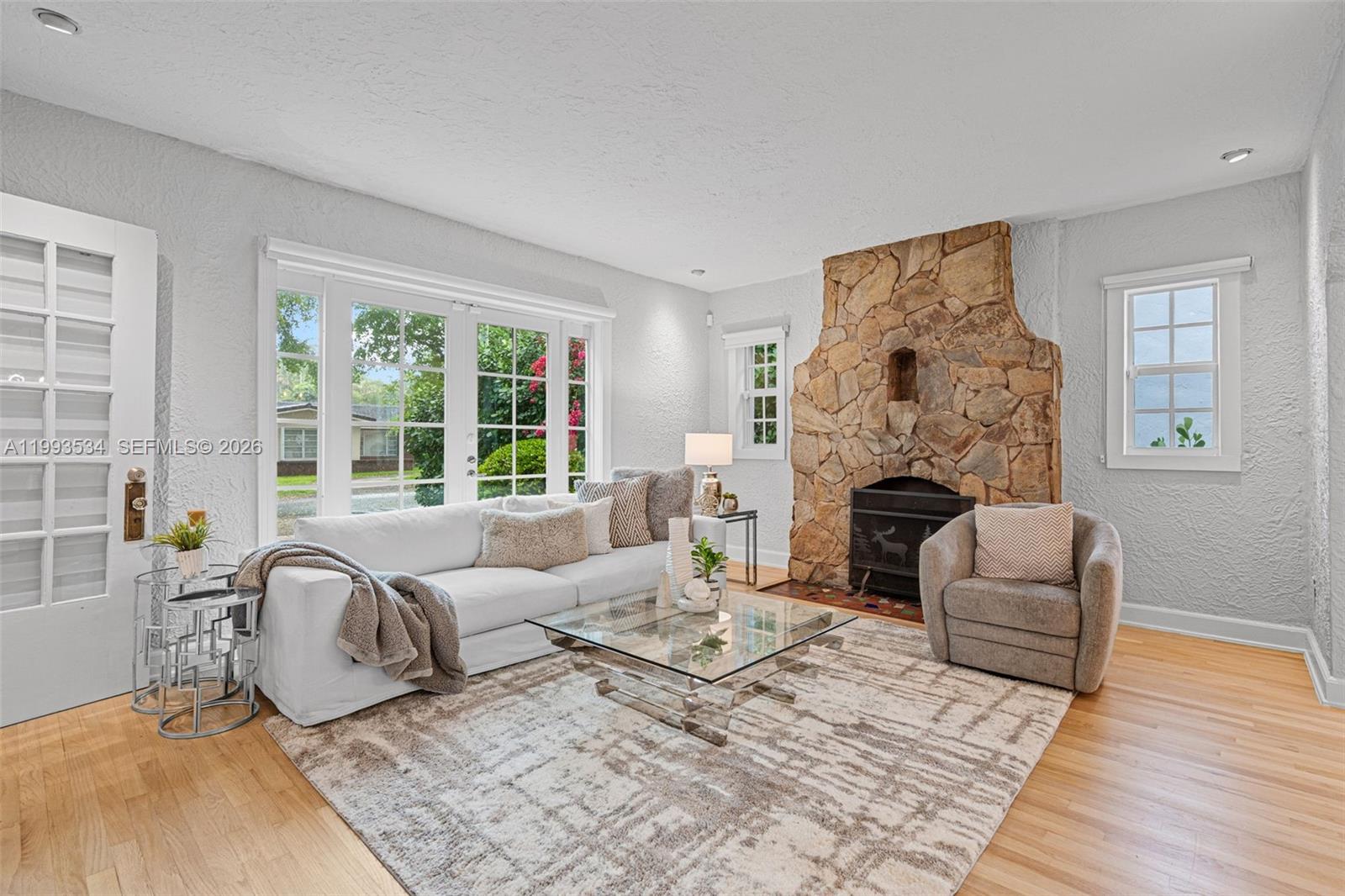 Timeless Old Spanish residence in the heart of Coral Gables, thoughtfully reimagined to blend historic character with modern luxury. Architectural details include a classic barrel tile roof, arched doorways, gorgeous HARDWOOD fllors, all with a Mediterranean-inspired design. The main home features a fully renovated kitchen and spa-inspired baths with high-end finishes and an open, functional layout. Major Capital Improvement made in the last 2.5 years.  Upgrades include a NEW ROOF, PGT HURRICANE IMPACT windows and doors, top of the line Carrier HVAC, updated electrical systems, new plumbing including copper line from the main, water heater, septic tank, sprinkler system, and new window shades. A detached "CASITA" offers approx. 200 sq ft of air-conditioned space—ideal for a guest suite, office, or gym. Light-filled interiors enhance warmth and elegance. Ideally located on a tree-lined street near top schools, dining, and shopping—this move-in-ready Gables gem offers history, flexibility, modern comfort with peace of mind. Showings by appointment. All fair offers being considered.