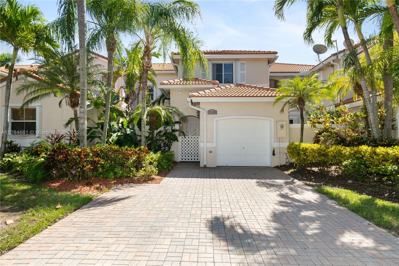 A special find in the gated West Lake Village development, within the highly desirable Hollywood beach community, this 2-bedroom 2.5-bath Mediterranean awaits its new owners. Tucked away on a tranquil no-thruway tree lined street, the home is a mere stroll to our famous beaches. The property features vinyl wood look floors, living & dining areas, the kitchen offers aromatic promise with natural light and attractive U-shaped layout. More than just refuge from the day, the well-appointed master bedroom includes a walk-in closet, sitting space, and private bath with separate tub and shower. The other bedroom is unique, ensuite, and designed w/ plenty of closet space. Attached one-car garage. The pavers patio is perfect for socializing. You're going to feel great waking up here every morning.
