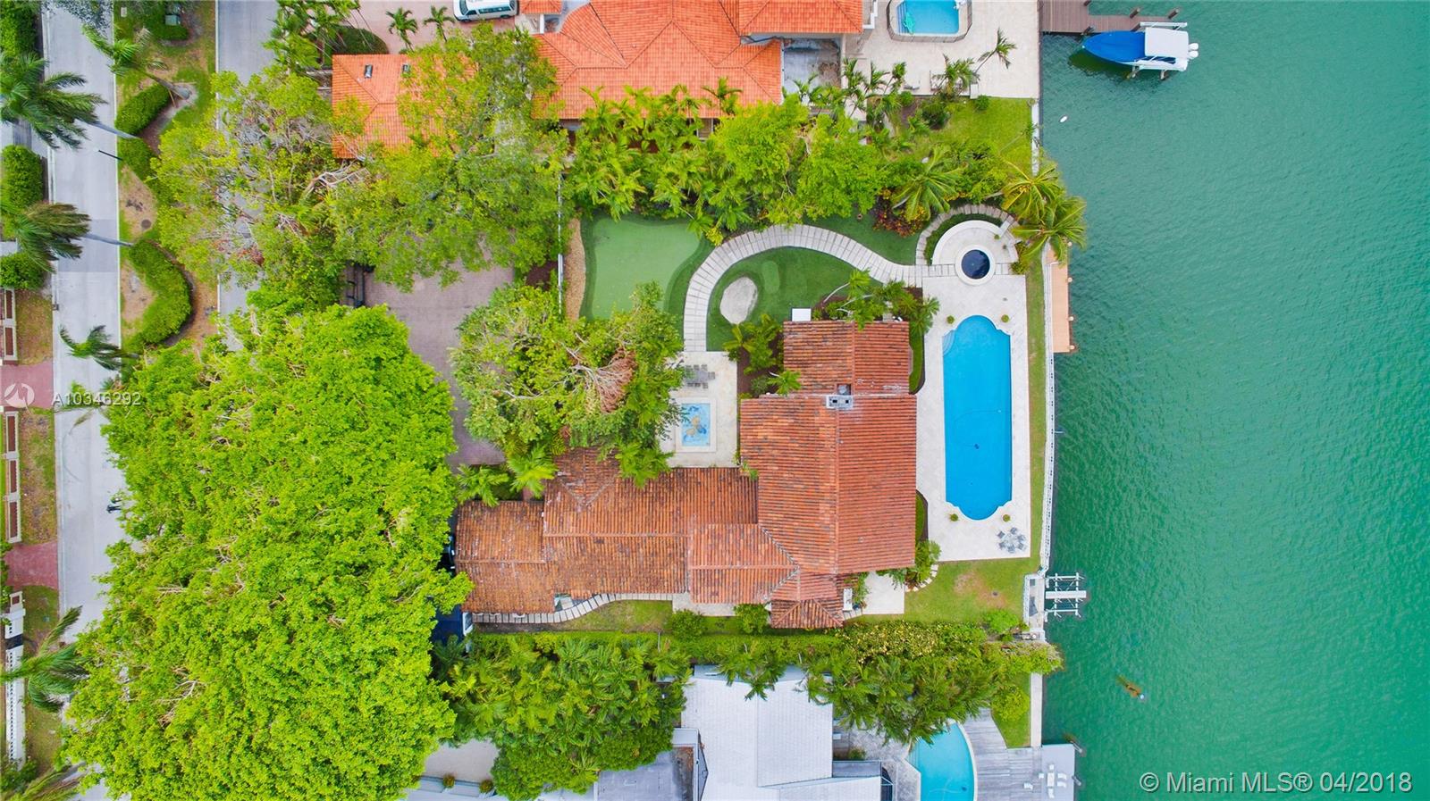 Rare 7 bd, 6.5 bath masterpiece designed by Palm Beach society Architect Maurice Fatio sits on a 30,000 sq. ft. lot. Boaters rejoice over protected deep waterfront of 135ft w dock, no fixed bridges & double jet ski lift. Located on exclusive guard-gated Allison Isl., Fatio's renowned talents are highlighted in this timeless estate. Fatio's other Florida icons include Indian Creek Golf & Country Club & former Vanderbilt mansion on Fisher Is. This one of a kind Villa, surrounded by mature banyan trees, features open gourmet gas kitchen, Waterworks baths, Jack Nicklaus-designed putting green, guest quarters, staff quarters w/kitchen & private courtyard w/water feature, billiards rm, Florida rm. Covered loggias & keystone terraces w/amazing Western sunset views, opening to 60ft pool w hot tub.
