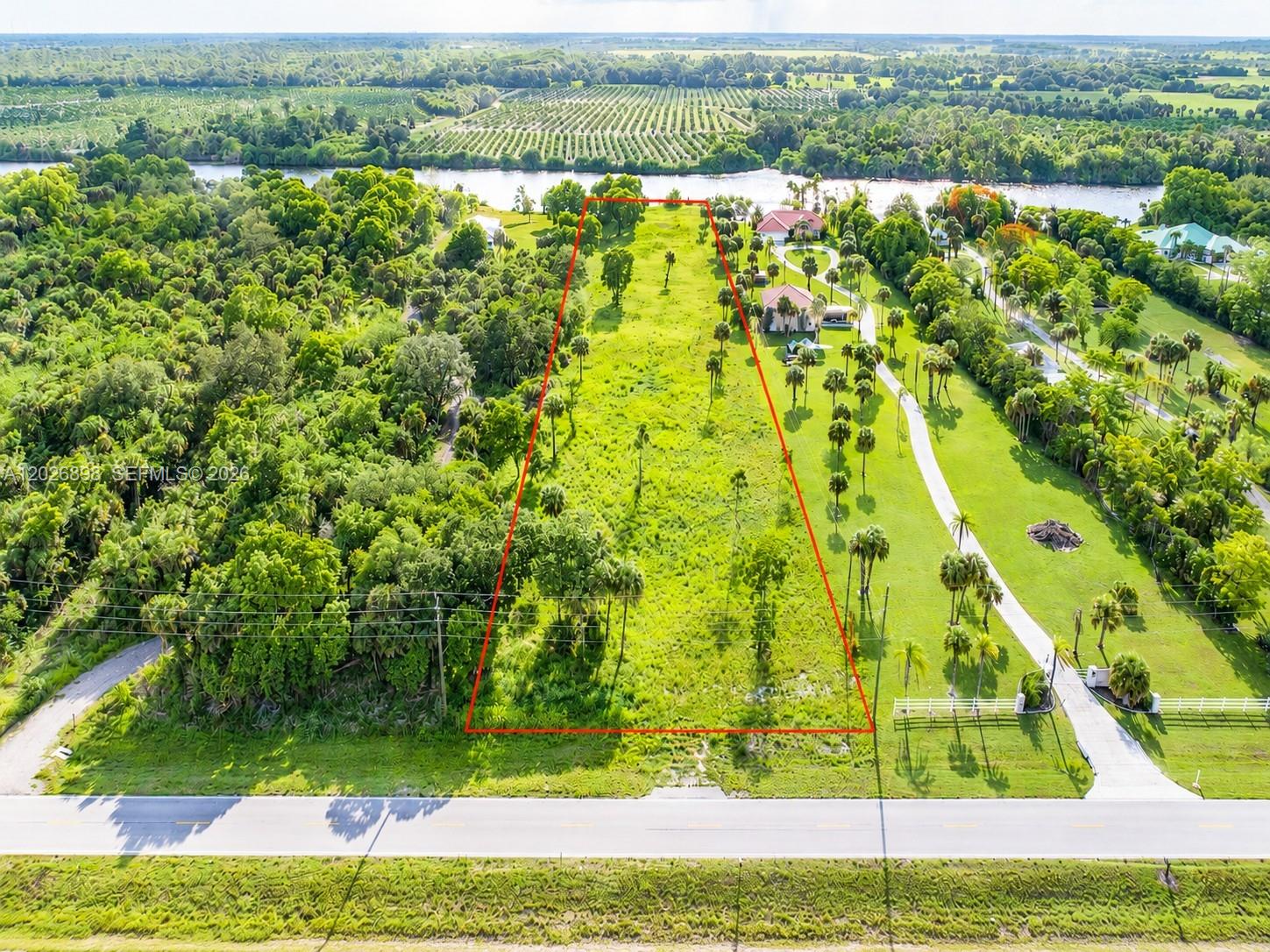 Discover the perfect blend of privacy, beauty, and convenience at 5220 Ft. Denaud Road. This exceptional 3± acre riverfront property offers approximately 160 feet of frontage on the breathtaking Caloosahatchee River, part of the Intracoastal Waterway. High and dry with no flood insurance required, the property boasts stunning panoramic water views and an elevated homesite ideal' for your dream estate.
Unlike many riverfront properties, your view across the river is protected by a sprawling 300± acre orange grove rather than neighboring homes, creating a peaceful and picturesque setting rarely found today. The land  has been lovingly underbrushed while preserving the maximum number of mature trees, offering privacy, natural beauty, and a tranquil old Florida atmosphere.
With approximately 160 feet of frontage on coveted Ft. Denaud Road and located just one-half mile from State Road 80, this property combines  secluded country living with quick and easy access to both Florida coasts.  Conveniently situated only 4 miles from the Lee/Hendry County line, you are close to shopping, dining, and amenities while still enjoying the  serenity of riverfront living.
