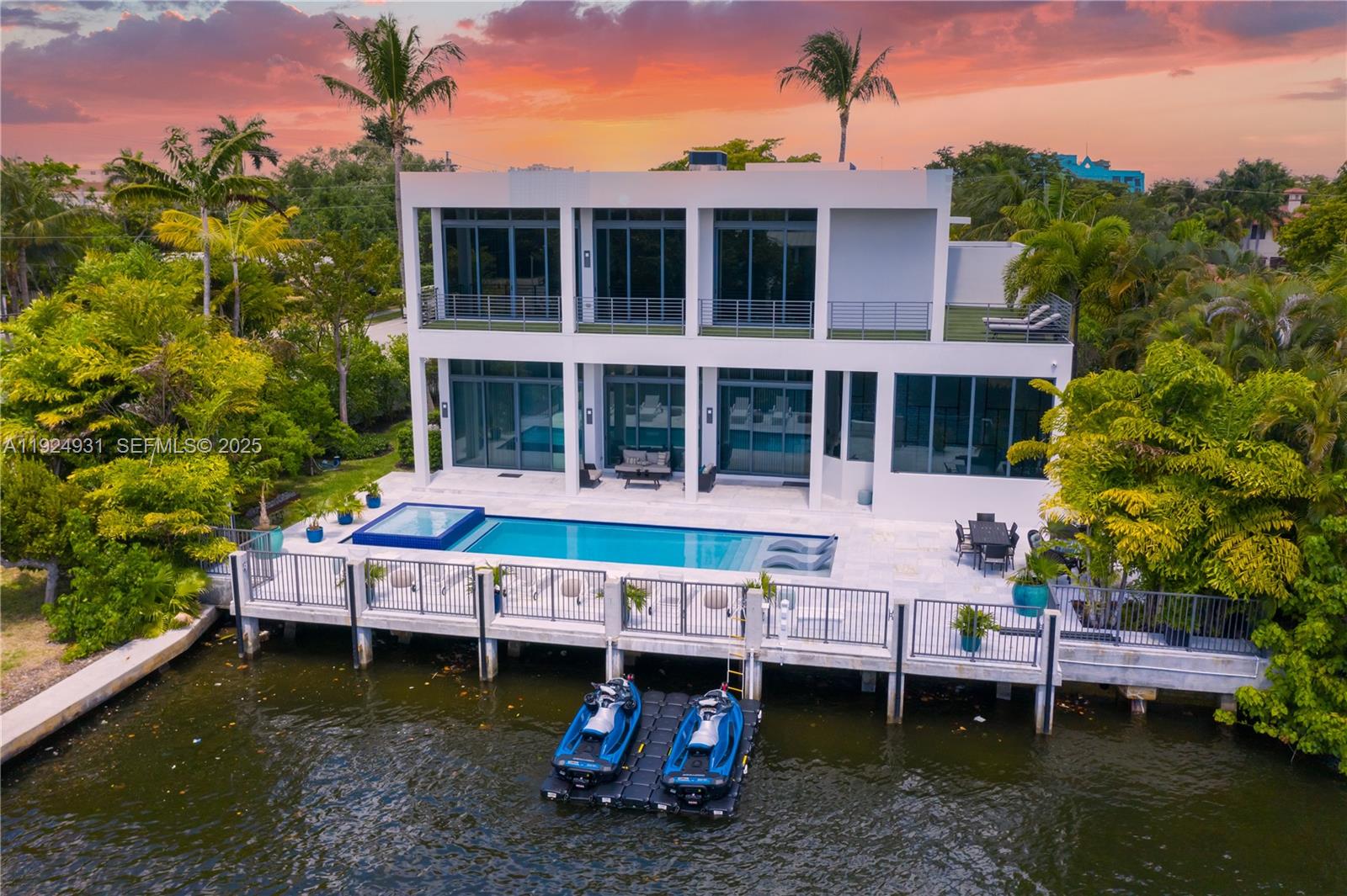 Stunning modern waterfront estate in Coral Ridge, offering 100 ft of yacht-friendly frontage and exceptional indoor-outdoor living. This impeccably designed home features an expansive open floor plan, top-of-the-line finishes, and a chef’s kitchen perfect for entertaining. The generous primary suite includes a spa-inspired bath and captivating Intracoastal views. Step outside to a private oasis with a heated pool, spa, and dock with easy access to the Intracoastal. Just minutes from fine dining, shopping, and the beach, this residence delivers true luxury and convenience in one extraordinary package.