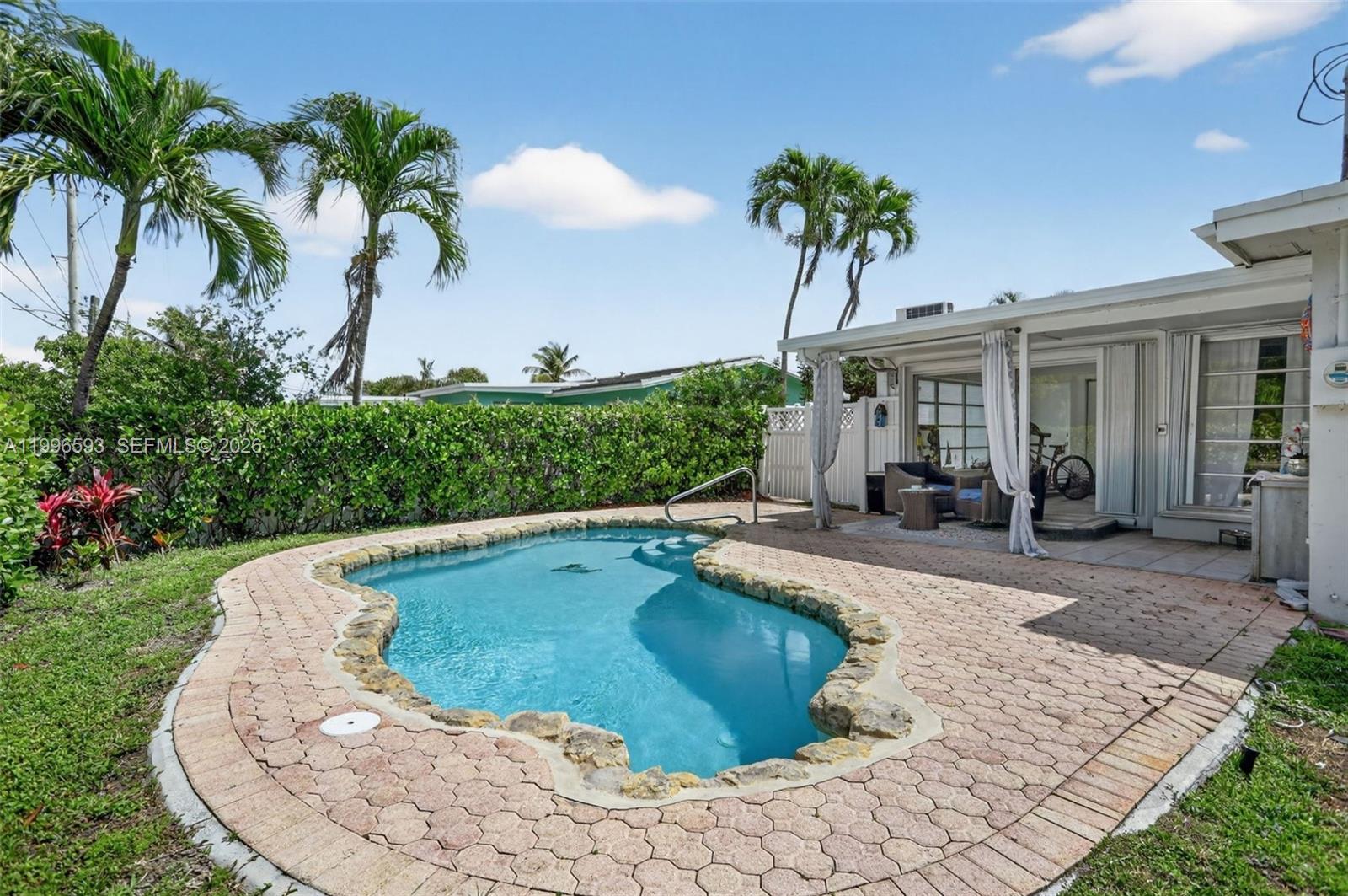 Updated Everything! NO HOA. Private Pool. Fully Move-In Ready for Peaceful Living in East Pompano Beach. 2020 Roof, 2021 Central A/C, and a Remodeled Bathroom. The Spacious Kitchen is the Heart of the Home - a Large Island with Seating and Hidden Storage, Light Stone Countertops, and Stainless Steel Appliances Designed for Everyday Living and Entertaining Alike. Bright, Open Living Spaces with Waterproof Vinyl Flooring Flow Throughout. A Bedroom with its Own Private Entrance Offers Ideal Flexibility for Guests, a Home Office, or Rental Potential. Outside, Enjoy a Fully Fenced PVC Yard, No Rear Neighbors, and Plenty of Space to Relax by the Pool Year-Round. Two Storage Sheds, Exterior Storage, and a Separate Laundry Room Complete the Space. Just Minutes from the Beach, Fishing Pier, Restaurants, Shopping, and the City's Rapidly Growing Downtown District. This One Checks Every Box.