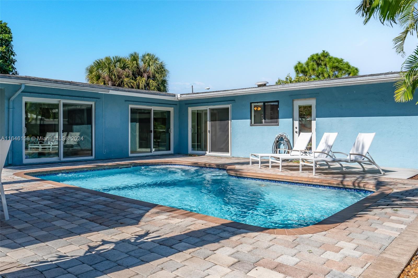 VERY UNIQUE AND OPEN FLOOR PLAN THAT HAS 3 SETS OF DOUBLE DOORS EXITING TO THE POOL BRINGING IN TONS OF LIGHT. SPLIT LAYOUT HAS THE PRINCIPLE BEDROOM WITH A REMODELED BATH AND A DOOR TO THE BACKYARD OPENING TO A PRIVATE PATIO. 2 MORE BEDROOMS AND A FLORIDA ROOM EQUIPPED AS A POSSIBLE QUEST ROOM, AND CONNECTING BATHS. THIS HOUSE HAS TO BE EXPERIENCED TO BE APPRECIATED. LOCATED ON AN OVERSIZED LOT WITH MATURE FRUIT TREES, FULLY FENCED AND PRIVATE BACKYARD. NEW ROOF, ALL IMPACT WINDOWS AND GARAGE IS CONVERTED TO A PLAYROOM W POOL TABLE. THIS HOME IS CURRENTLY RENTED OUT AS A VACATION RENTAL WITH RESERVATIONS IN PLACE. CAN BE BOUGHT FULLY FURNISHED AND READY TO GO AS AN ONGOING BUSINESS. SHOPPING AND POMPANO BEACH WITHIN A MILE. CALL VALERIE FOR OPEN DATES TO SHOW.
