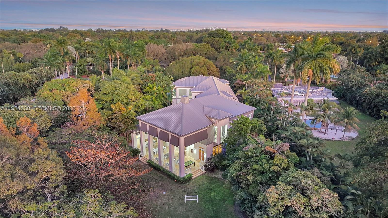 Set on a rare 1.3-acre estate, this exceptional Plantation residence offers remarkable scale, privacy, and architectural presence. The home unfolds with dramatic volume ceilings, expansive walls of glass, and beautifully proportioned living spaces designed for both refined living and grand entertaining. A statement kitchen anchors the interior with an oversized island, professional-grade appliances, custom millwork, and seamless flow to the main living areas. The residence features seven bedrooms and six full, 1 half bathrooms, thoughtfully laid out to provide privacy, balance, and comfort throughout. Outdoor living is equally compelling, highlighted by a resort-style pool, coral stone terraces, multiple covered seating areas, two outdoor kitchens, and a striking gas fireplace—creating an atmosphere ideal for entertaining or quiet retreat. Impact windows and doors, a modern metal roof, multiple HVAC systems, tankless water heaters, and a four-car garage complete the offering. With no HOA, the estate offers uncommon flexibility, allowing for luxury Airbnb use or an exceptional private residence. Ideally positioned near Las Olas, downtown Fort Lauderdale, and major highways, this estate delivers a rare combination of elegance, functionality, and estate-scale living.