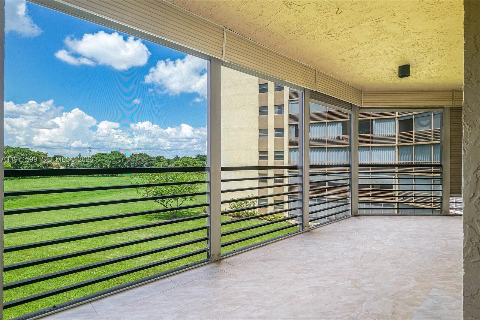Discover the largest floor plan in the building with this magnificent 1,972-square-foot corner condo. Located on the third floor of a premier 55+ community, this residence feels like a private home thanks to soaring 10-foot ceilings and extra windows that flood the space with natural light. The open-concept interior features stunning vinyl flooring throughout, leading to a gourmet kitchen complete with sleek quartz countertops and stainless steel appliances. A dedicated washer and dryer are located within the unit for total convenience. The standout feature is the expansive wraparound patio, offering a perfect vantage point for spectacular golf course views and breathtaking sunsets. For year-round peace of mind, the entire patio is protected by hurricane shutters. This unit also includes two dedicated parking spots plus ample guest parking. High-speed fiber-optic internet and an expanded cable package are included in the monthly dues, as are water, sewer, and pest control. The community is currently undergoing exciting renovations and installing a new security entry system, promising significant future value for the owner. Residents enjoy a world-class cultural center with heated pools, a spa, gym, bowling, pickleball, and a library. Residency requires a credit score of 700+ and a minimum annual income of $85,000. ==See Broker's remarks==