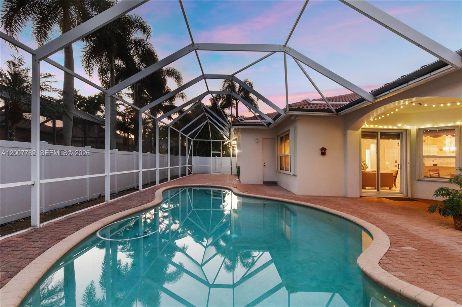 Luxury and effortless style; updated one-story home, first time on the market in years. Brand-new flat tile roof (March 2026) and sleek stainless steel kitchen with quartz countertops (March 2026), refreshed baths shine with modern quartz finishes. Volume ceilings with recessed lights welcome all who enter this lovely family home with sparkling pool and 3 car garage. Other key upgrades include: 2025  sprinkler system, accordion hurricane shutters (2023), water heater (2024), Goodman AC (2021) and 6' tall vinyl fence (2022) make this home move-in ready and worry-free. Wake up in your spacious master suite large enough for king-sized bed, a bay window sitting area and ensuite master bath behind double doors for complete split plan privacy. Entertain with ease in open yet thoughtfully defined living spaces, step outside to your screened patio, a private oasis perfect for relaxing or dining al fresco by the pool. With 4 bedrooms, 3 baths, a 3-car garage, and 3,927 q ft of total living area, this home offers the perfect blend of style, comfort and luxury. Located in the highly coveted gated Pasadena at Pembroke Shores community - complete with 24-hour manned security, top schools, parks, and easy access to I-75 - homes like this don’t come along often. Please request appointments via Show Assist 24 hours notice a must.  Seize this rare opportunity before it’s gone!