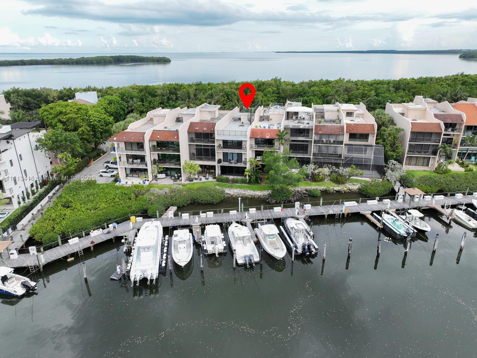Incredible 4 story townhome - New Roof, Impact Glass, ACs, Water Heaters, Washer/Dryer, Motor Shades. Sip coffee as yachts go by behind your home or enjoy drinks at community private beach. This unit is situated ideally to enjoy breathtaking views of Deering Golf Course, Downtown Miami Skyline, South Beach Skyline & Biscayne Bay. Large lower level with 1/2 bath perfect for entertaining large parties or movie theater. Main level offers modern eat-in kitchen with chic white cabinets & quartz countertops. The master is a retreat unto itself including 3 walk-in closets, a spa-like shower & jetted bathtub. Large balcony offering incredible views. Last is a massive 1500 sq/f rooftop space with railings & a spiral staircase showcasing the spectacular 360 views available at this price point.