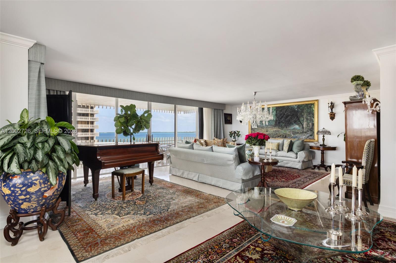 A rare offering in the coveted 09 line at Grove Isle, this beautifully updated 3-bedroom, 2.5-bath residence showcases sweeping water views and refined, light-filled interiors. Expansive living spaces include an oversized living room, family room, formal dining area, and a separate breakfast space designed for both relaxed daily living and elegant entertaining. The private primary suite serves as a tranquil retreat with its own balcony, custom walk-in closet, and a marble-appointed bath with bespoke finishes. Thoughtfully renovated, the home features premium imported wood flooring, a marble kitchen with custom cabinetry, wine refrigeration, and an alkaline water system, along with a dedicated laundry area. Enhanced with designer details, solid-core doors, and sun control film, this residence is set within a guard-gated island community offering resort-style amenities, marina access, and proximity to Coconut Grove’s vibrant dining and lifestyle.