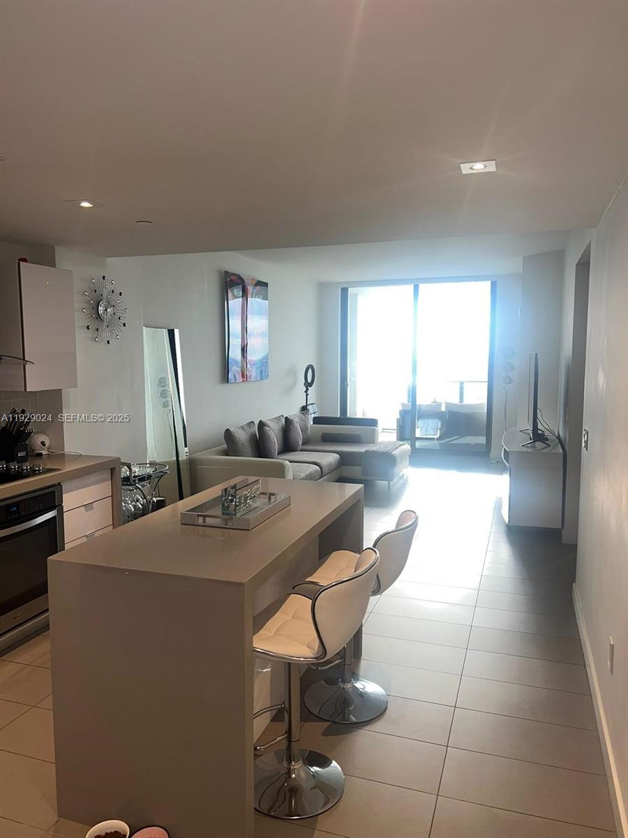 Luxury 1 bedroom + den & 1 full bathroom. Building is only on block from the metro-mover of Miami. Floor to ceiling glass windows, European kitchen and SS kitchen aid series II appliances, The building amenities include 3 experimental pools, jacuzzi, spa, gym, yoga and meditation areas, high speed internet throughout the entire building, glass racquetball court, movie screening theater, music practice studio, modern game room, outdoor lounge, BBQ area and much more!! *Washer and dryer inside the unit**