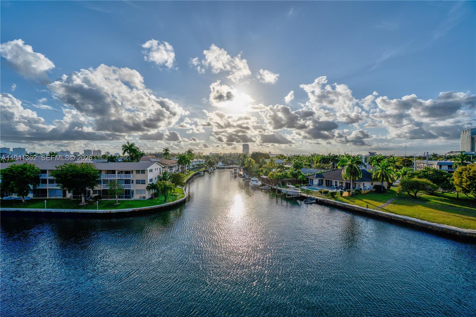 Breathtaking, unobstructed waterfront views greet you from this spacious corner unit, offering front-row seats to the daily parade of boats gliding by and some of the most spectacular sunsets Southwest Florida has to offer. Watch the sky explode in vibrant pinks, oranges, and purples as the sun dips below the horizon—truly a nightly masterpiece visible from both the open living area and the serene master bedroom.This bright 2-bedroom, 2-bathroom residence features brand-new hurricane-impact windows and doors throughout for peace of mind and energy efficiency, along with a generous closet space and a dedicated storage space for added convenience. Enjoy low HOA fees in a well-maintained community with no leasing allowed, ensuring a quiet, owner-occupied atmosphere.Perfectly located just minutes from pristine Gulf beaches, world-class shopping, exceptional dining, and the excitement of Gulfstream Park—everything you need for the ultimate Florida lifestyle is right at your doorstep.