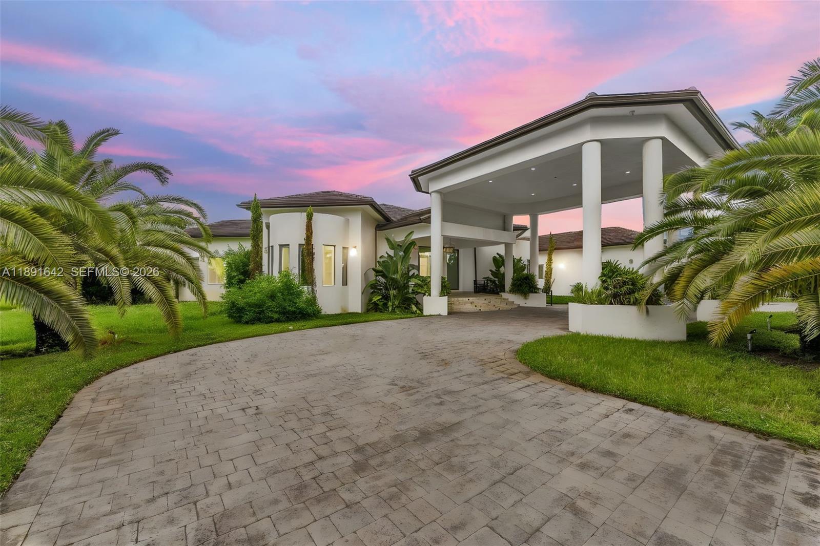 In Miami’s prestigious Horse Country, where sprawling estates meet equestrian grace, lies a residence built for those who dream big. Past a grand porte-cochere, this 8-bedroom, 8.5-bath architectural masterpiece unfolds in marble, glass, and light. Every suite is a private retreat, every corner a statement of design. Entertain in the wine room, gym, or at the resort-style pool with jacuzzi, bar, and cabana kitchen—your personal outdoor oasis. Fully gated, with impact glass and a generator, this home whispers privilege and potential. Vacant yet alive with possibility, it awaits the visionary who sees not what it is—but what it can become.