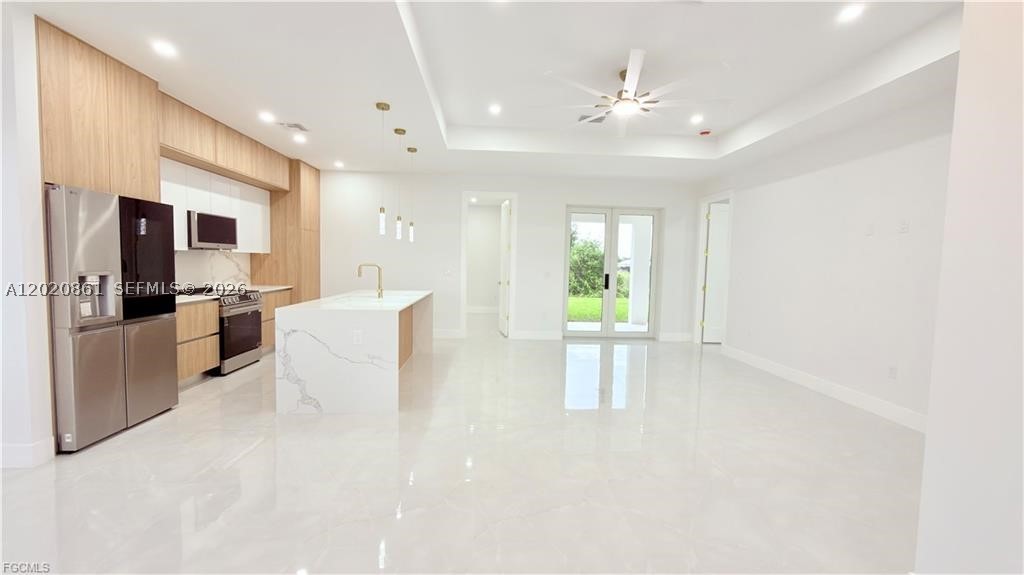 New Construction Home with Private Mother-in-Law Suite! Welcome to this beautifully crafted new construction home offering nearly 2,000 sq. ft. of living space, designed with comfort, style, and flexibility in mind. This exceptional property features 4 bedrooms, 3 bathrooms, and a spacious 2-car garage, including a private mother-in-law suite with its own separate entrance. The suite includes 1 bedroom, living area, kitchen, bathroom, and washer/dryer hookups already in place, ideal for extended family, guests, or potential rental income opportunities. Situated on a desirable corner lot on a dead-end road, just off Lee Blvd, this home offers the perfect combination of convenience, privacy, and functionality. Inside, you’ll find elegant porcelain tile flooring throughout, impact windows and doors, and a bright open-concept layout filled with natural light. The modern kitchen is designed to impress, featuring quartz countertops, wood cabinetry, and stainless steel appliances, perfect for everyday living and entertaining. The owner’s suite offers a relaxing retreat with dual walk-in closets and a beautiful primary bathroom with double sinks. Step outside and enjoy true Florida living on the spacious lanai, complete with a summer kitchen — perfect for outdoor dining, family gatherings, and year-round entertaining. This home offers the ideal blend of modern design, flexible living space, and a prime location. Don’t miss the opportunity to see everything this property has to offer.