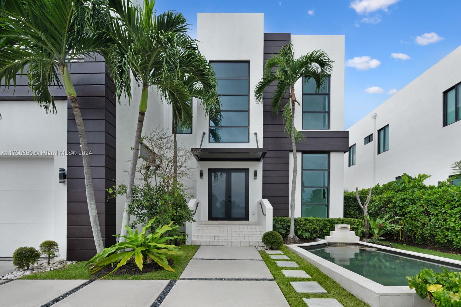 Introducing this stunning two-story waterfront home in the exclusive, guard-gated San Souci Estates. Built in 2016, this 4,800+ SQFT luxury residence boasts 12+ ft high ceilings, an open floor plan, grand entrance w/ double height ceilings, 6 bedrooms, a den/office, and 7 bathrooms. Enjoy 75+ ft of WF with direct bay/ocean access, no fixed bridges, a saltwater pool, jacuzzi, private dock, and boat lift. The chef’s kitchen features a Wolf gas cooktop, Sub-Zero fridge/wine cooler, ample seating space all w/ breathtaking water views. The expansive master suite offers dual walk-in closets, a large shower with tub, separate sinks, + a private balcony. Park your cars in a two-car garage, 4 car driveway! 24/7 security as well
