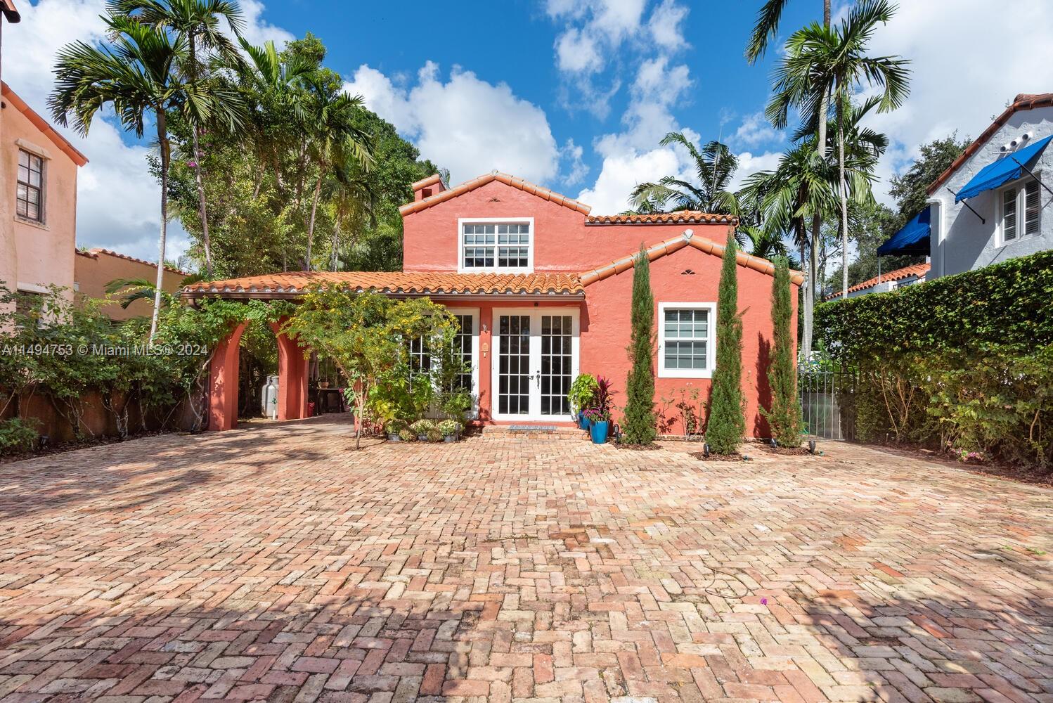Nestled in Coral Gables' prestigious and Historic Italian Village, this gated Landmark property awaits a discerning buyer. Designed by famed Architect Robert Weed Law this property reflects his influence in local design and style. From the moment you step into the Chicago brick courtyard and enter the sunroom filled with natural light, you know you are in a special place. The interior spaces are updated, open and bright making for easy gathering, entertaining and access to a private rear courtyard with a detached Cottage. Home has recent major upgrades for financial ease of ownership.