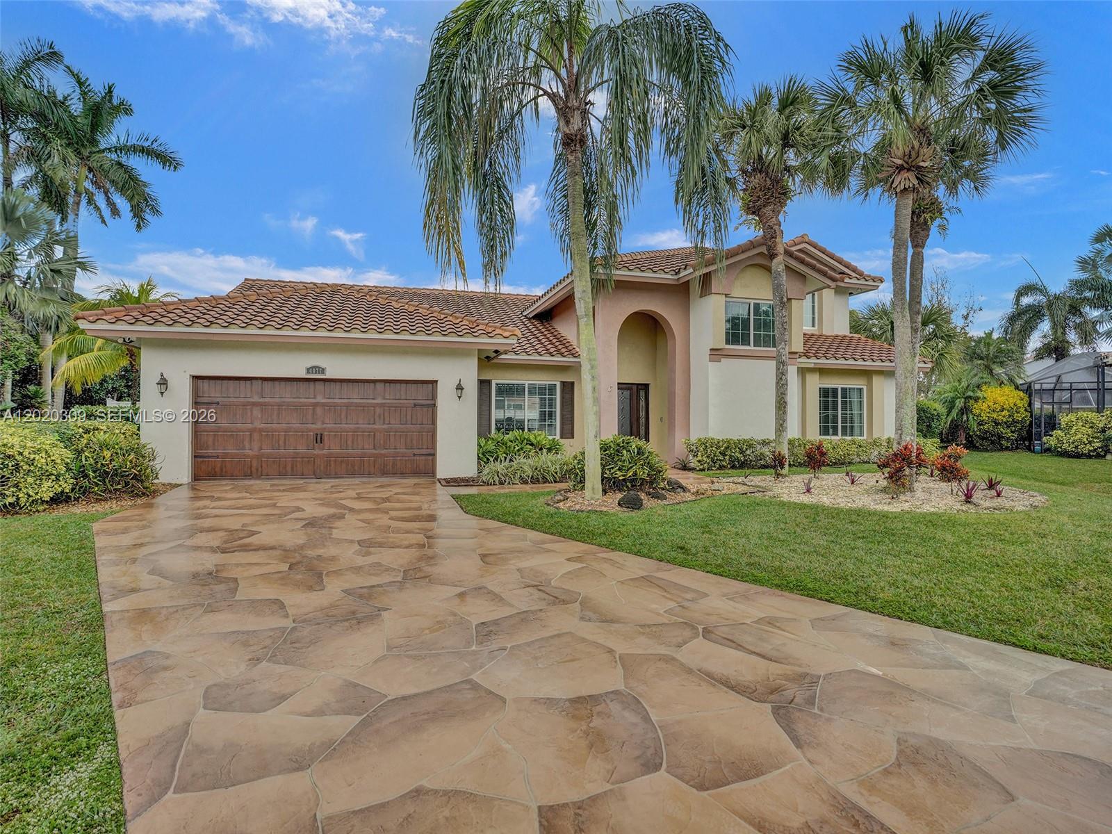 Located in the highly sought-after gated community of Carriage Pointe Estates, this remodeled home sits on a peaceful cul-de-sac and features 4 spacious bedrooms and 3 well-appointed bathrooms, offering comfort and functionality throughout. Step inside to discover high ceilings and an open-concept floor plan designed for everyday living. Natural light fills the home through expansive glass doors, creating a seamless connection to the private outdoor area. The patio and pool deck provide a great setting for relaxing or entertaining, while the fenced yard offers privacy and space to enjoy the outdoors. The thoughtfully designed layout includes a primary suite and an additional bedroom conveniently located on the main floor. The updated kitchen features stainless steel appliances, granite countertops, and ample cabinet and prep space. With a 2017 roof, newer AC units, impact windows, and accordion shutters, this home also offers added peace of mind. Low association fee includes security and 24-hour manned gated entry.