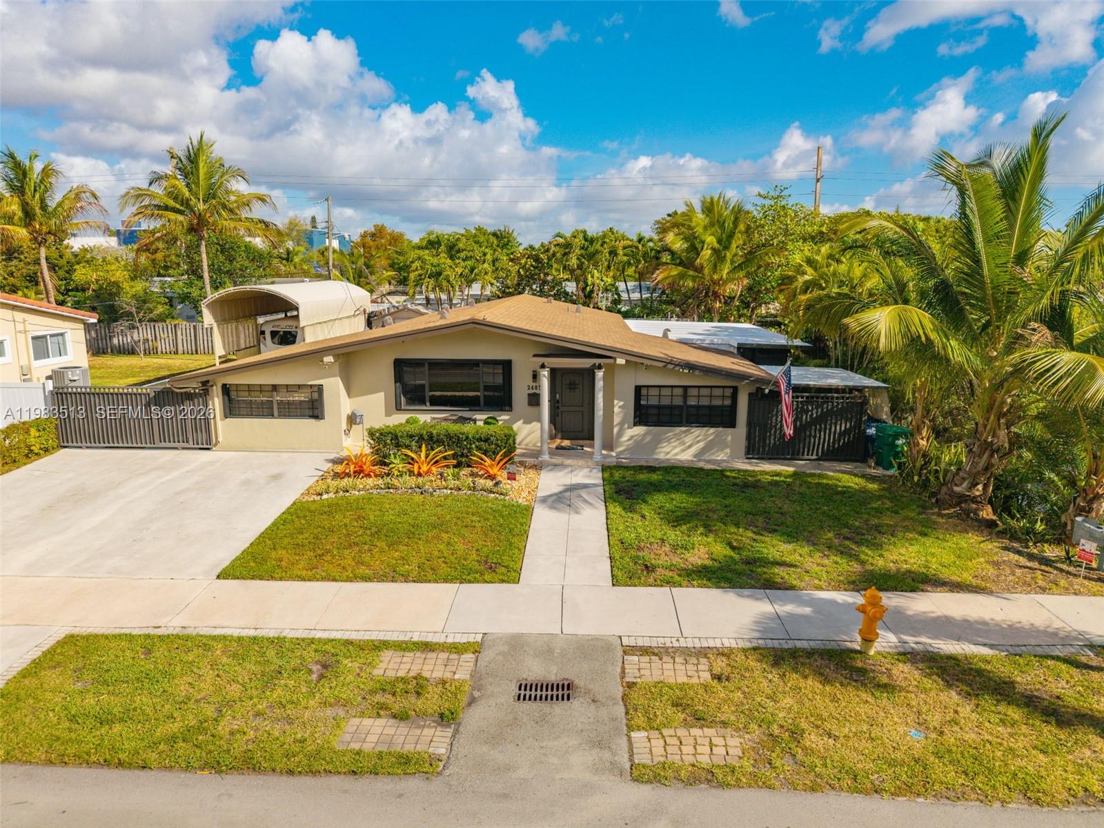 Beautifully maintained one-story home in the highly sought-after Highland Lakes neighborhood, just minutes from Aventura Mall, beaches, parks, shopping, and dining. This bright and spacious residence offers comfortable living areas and several valuable upgrades including renovated bathrooms, an automatic backup generator, and new A/C and electrical panel replaced in 2025. Roof replaced in 2018. A canal runs along the east side of the property, and the home features a covered patio/deck area perfect for relaxing, BBQs, and outdoor entertaining. The property also includes a covered RV/boat parking area with awning and in-law quarters, offering flexibility for extended family or guests. Generous lot in a quiet residential neighborhood within walking distance to houses of worship and conveniently located near parks, major roads, and Aventura shopping.