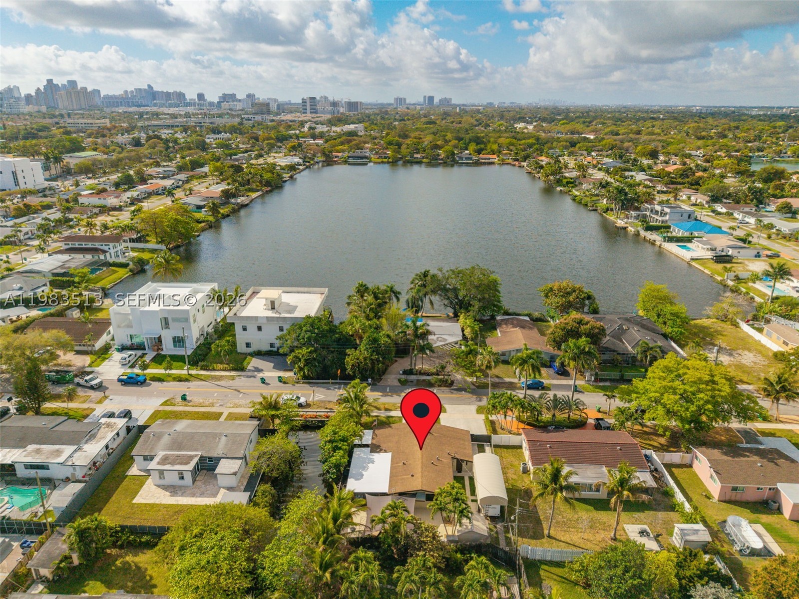 Beautifully maintained one-story home in the highly sought-after Highland Lakes neighborhood, just minutes from Aventura Mall, beaches, parks, shopping, and dining. This bright and spacious residence offers comfortable living areas and several valuable upgrades including renovated bathrooms, an automatic backup generator, and new A/C and electrical panel replaced in 2025. Roof replaced in 2018. A canal runs along the east side of the property, and the home features a covered patio/deck area perfect for relaxing, BBQs, and outdoor entertaining. The property also includes a covered RV/boat parking area with awning and in-law quarters, offering flexibility for extended family or guests. Generous lot in a quiet residential neighborhood within walking distance to houses of worship and conveniently located near parks, major roads, and Aventura shopping.