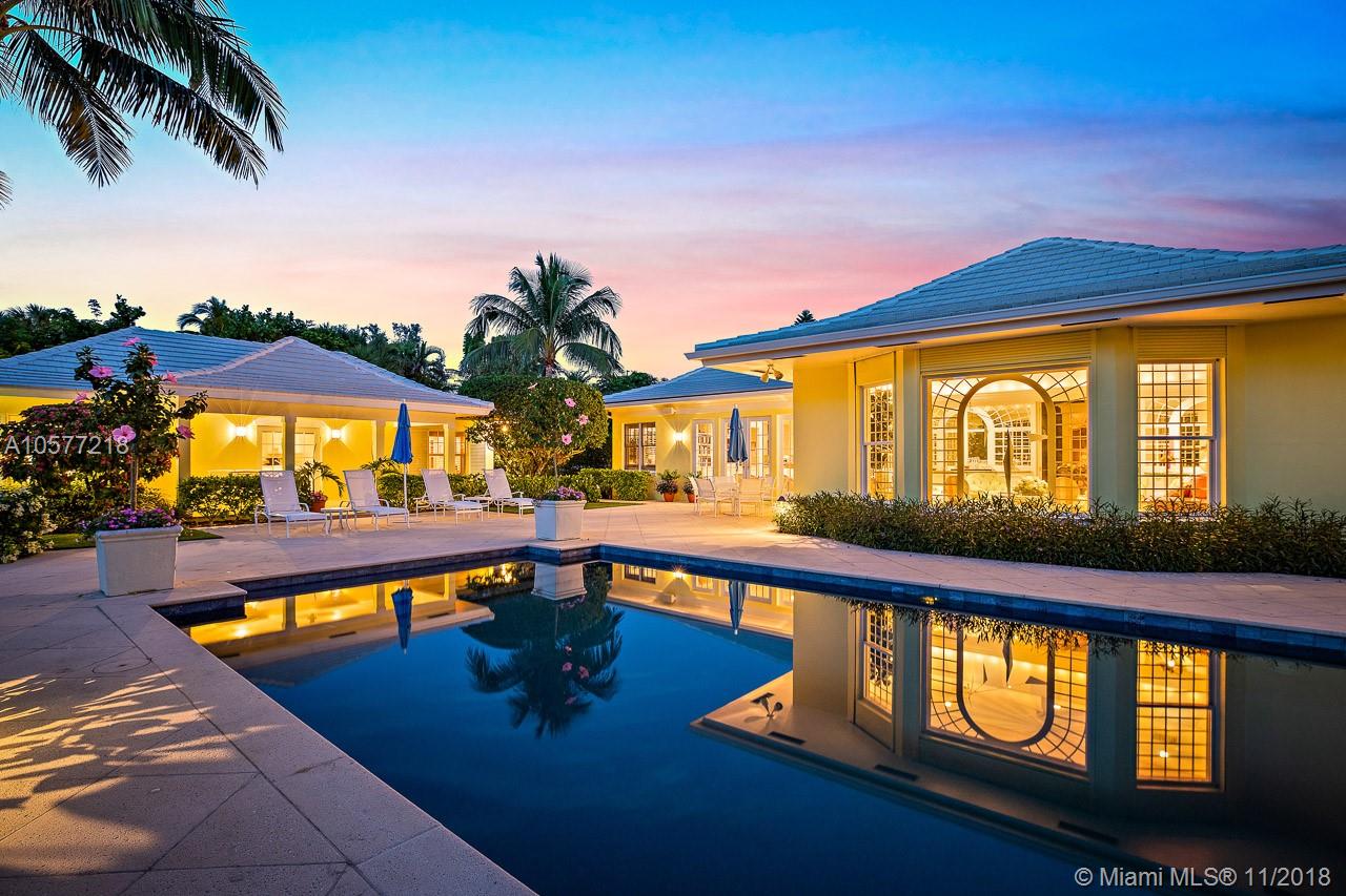 Sitting on almost one full acre and surrounded by a lush ficus hedge to ensure the utmost privacy, this beautifully designed and decorated Jupiter Island house with two separate guest cottages is the ultimate in gracious living. The main house features an enormous master bedroom with two master baths, expansive closets and serene views of an elegant reflecting pool/fountain. There are numerous entertaining spaces including a formal living room with a fireplace, trellised glassed conservatory, formal dining room and enormous family room and kitchen.  Each of the two guest houses has two bedrooms and a kitchen.  All the structures were completely rebuilt from the ground up in 2008 with superb finishes including rare woods, elegant marble and impact windows.