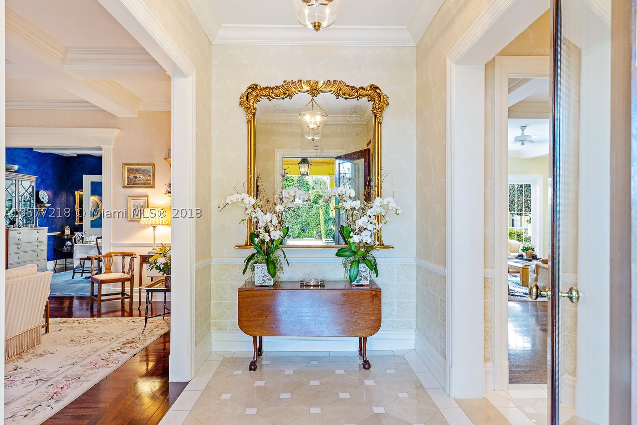 Sitting on almost one full acre and surrounded by a lush ficus hedge to ensure the utmost privacy, this beautifully designed and decorated Jupiter Island house with two separate guest cottages is the ultimate in gracious living. The main house features an enormous master bedroom with two master baths, expansive closets and serene views of an elegant reflecting pool/fountain. There are numerous entertaining spaces including a formal living room with a fireplace, trellised glassed conservatory, formal dining room and enormous family room and kitchen.  Each of the two guest houses has two bedrooms and a kitchen.  All the structures were completely rebuilt from the ground up in 2008 with superb finishes including rare woods, elegant marble and impact windows.