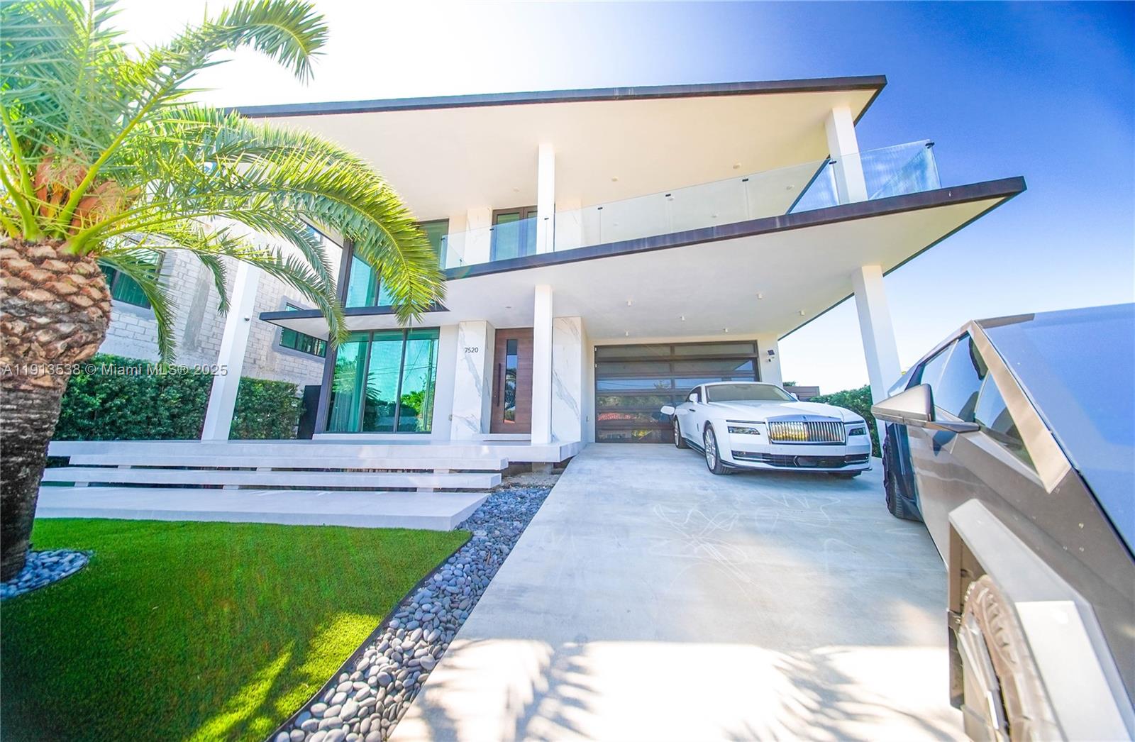 Discover unparalleled waterfront luxury in this 2022 modern masterpiece showcasing mesmerizing Biscayne Bay and Miami skyline views. The residence features soaring double-height ceilings, expansive glass walls, a chef’s gourmet kitchen, and a serene bayfront primary suite. Enjoy six ensuite guest rooms, resort-style pool, summer kitchen, rooftop terrace, and 60-ft dock. Located in North Bay Village