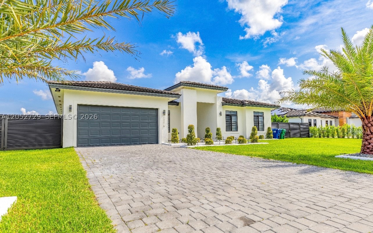Experience the comfort of this 2020-built residence offering 4 bedrooms and 3.5 bathrooms in a recently established neighborhood. The interior showcases an airy open floor plan with impressive high ceilings, complemented by formal living and dining spaces and a spacious family room illuminated by French impact doors. The private primary suite is generously sized and features large walk-in closets along with its own en-suite bathroom. Outdoors, the oversized 14,000+ sq. ft. lot provides a covered patio for entertaining and ample space for boat and RV parking. Beautiful tropical palms and attractive landscaping complete the property's exceptional curb appeal.