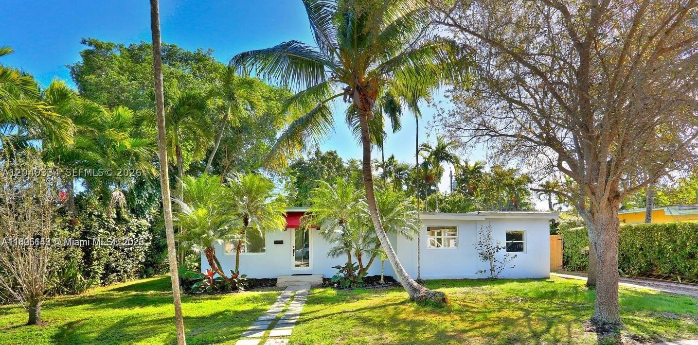 Full of personality, with stylish design choices and tons of character throughout. Think polished concrete floors, open beam ceilings, colorful painted tile, renovated baths. The eat-in kitchen features gas cooktop, wall oven, French door fridge, concrete counters, and open shelving. Impact windows and doors for peace of mind. There's even extra storage cleverly tucked away and a laundry room. The backyard is generously sized and surrounded by mature trees — perfect for relaxing and entertaining.
Zoned for David Fairchild Elementary, minutes from downtown South Miami and Coral Gables, and walking distance to SoMi Park — this is one of the best walking and biking neighborhoods around. Available August 1. Rent where you actually want to live. This is rental living with flair. You'll love it here.