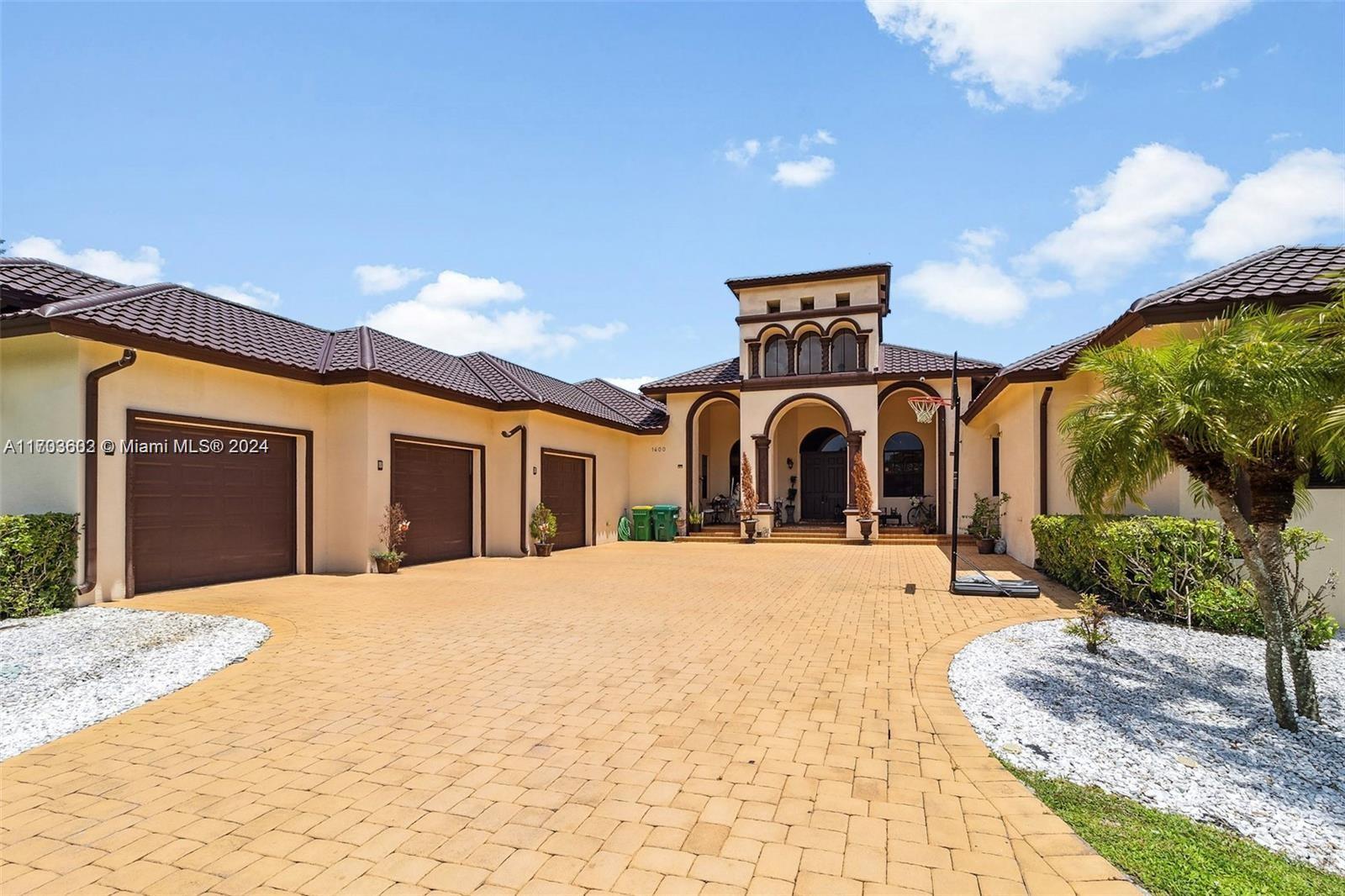 Magnificent custom home with an abundant amount of natural light located in the exclusive Plantation Acres.
Featuring 6 bedrooms, 7 bathrooms, a detached mother-in-law suite, and pool house. Enjoy high ceilings, a renovated chef's kitchen with new appliances, state-of-the-art security, and a surround sound system in both the family room and pool house. 5,500 sq. ft. of air-conditioned space. Newly completed metal roof in 2024 (30 year guarantee until 2054) and a resort-style patio and pool area. Prime location, just minutes from I-595 and I-75.