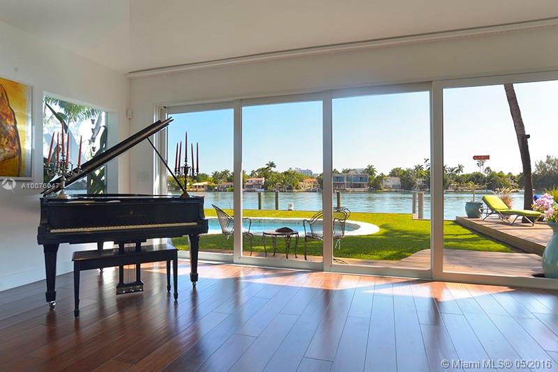 Rebuilt in 2010 this stunning tropical modern home features three bedrooms, three and 1/2 bathrooms. Highlights include European chef kitchen, open plan living and dining, lofted ceilings throughout, 8" wide Brazilian walnut wood floors, Lutron lighting, showcase glass door garage with lifts to accommodate four cars. Coveted SE corner exposure to cool breezes during the summer months and protection from NW storms in winter months. Spacious rear yard with entertainment deck and 105 feet wide bay views.