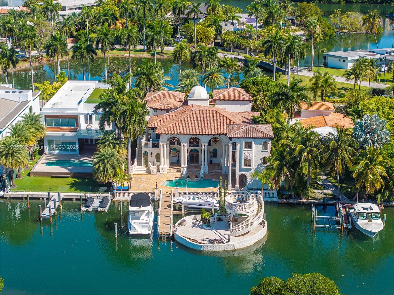 Built in 2009 with only the original 1946 garage walls preserved, this exceptional waterfront residence combines timeless elegance with modern enhancements. Two thoughtfully designed additions elevate the estate: a spacious 2-bedroom plus den, 2-bath in-law quarters completed in 2024, and a serene poolside guest house added in 2018. The entire structure is anchored by over 150 auger cast piles. Situated on 80 feet of prime water frontage, the property offers docking for two vessels—accommodating a boat up to 55 feet and a lift for one up to 26 feet. Gas-equipped gourmet kitchen and a private 1,000 sq ft island. Located on an ultra-private island of just 69 homes, this rare gem is within walking distance to the beach. Residents enjoy access to a gated, owner-exclusive beachfront parcel. Seller Finance 50%.