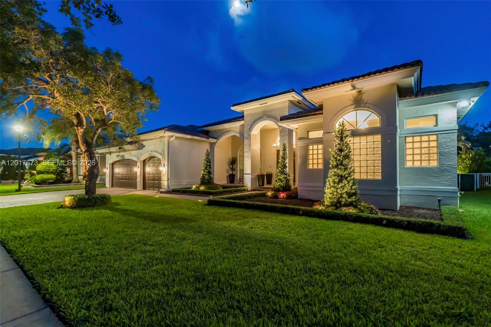 Experience elevated living in this beautifully updated and meticulously maintained residence offering the perfect blend of luxury, comfort, and functionality. The property has been exceptionally cared for over the years and thoughtfully redesigned with high-end finishes and modern upgrades throughout. From the moment you arrive, the refreshed landscaping, updated exterior lighting, and impressive curb appeal set the tone for what awaits inside. The home features porcelain flooring throughout, fresh interior and exterior paint, designer lighting, custom details, and spacious light-filled living areas ideal for both everyday living and entertaining. Offering 5 bedrooms with 5 built-in walk-in closets, a high-end custom-made office, impact windows and doors throughout, and a custom-built garage, this home was designed with both style and practicality in mind. The remodeled chef’s kitchen showcases quartz countertops, premium KitchenAid appliances, custom hardware, and a stunning wood-accented bar area that adds warmth and character to the space. The backyard has been transformed into a private retreat featuring a resurfaced pool with updated lighting, lush tropical landscaping, cooling-technology turf, patio fans, and enhanced privacy greenery, creating the ultimate indoor-outdoor South Florida lifestyle. Additional upgrades throughout the home further enhance the move-in ready appeal of this exceptional property.