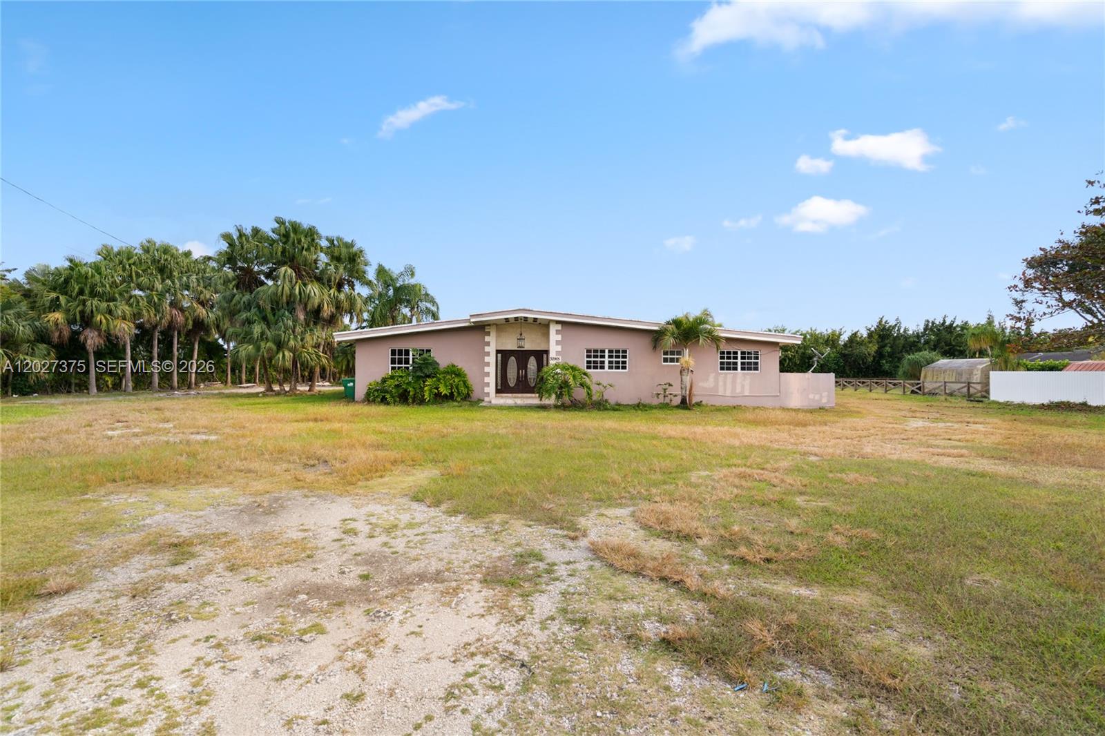 Privately gated and surrounded by lush mature landscaping and producing lychee groves, this rare approximately 3-acre property offers a unique opportunity to create a luxury private estate, family compound, or future residential development in the heart of the Redland. Located within Miami-Dade’s Urban Development Boundary (UDB), the property combines privacy, land, and long-term upside in one of South Florida’s fastest-growing areas.

The existing residence and pool create an established lifestyle setting with the flexibility to enjoy immediately, renovate, expand, or generate rental income while planning future improvements. The property’s natural beauty, expansive green spaces, and agricultural charm offer a peaceful retreat atmosphere rarely found so close to Miami.

Dual street access provides added flexibility, convenience, and privacy, making the property ideal for a custom estate residence, guest house, equestrian-style living, or multigenerational compound. The size and layout also present potential opportunities for subdivision or future residential development, subject to buyer verification with Miami-Dade County.

Surrounded by new growth while still preserving the character and tranquility that make the Redland so desirable, this is a rare opportunity to acquire a substantial land holding with endless possibilities. Conveniently located near major highways, Homestead, Miami, and the Florida Keys.