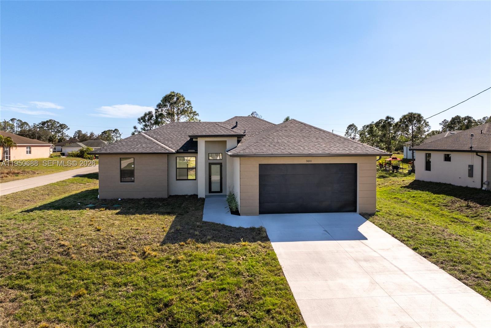 New construction home situated on a desirable corner lot in Lehigh Acres, Florida. This beautifully designed residence features 3 spacious bedrooms and 2 modern bathrooms, blending comfort, style, and functionality. The open-concept layout showcases elegant porcelain flooring, sleek quartz countertops, and a chef-inspired kitchen equipped with stainless steel appliances, contemporary fixtures, stylish cabinetry, and under-cabinet lighting, ideal for both everyday living and entertaining. The primary suite includes a thoughtfully designed built-in master closet offering ample storage and organization. Additional highlights include a built-in laundry closet, modern lighting fixtures, and updated faucets throughout. Conveniently located near shopping, dining, and essential amenities. Don’t miss this exceptional opportunity.