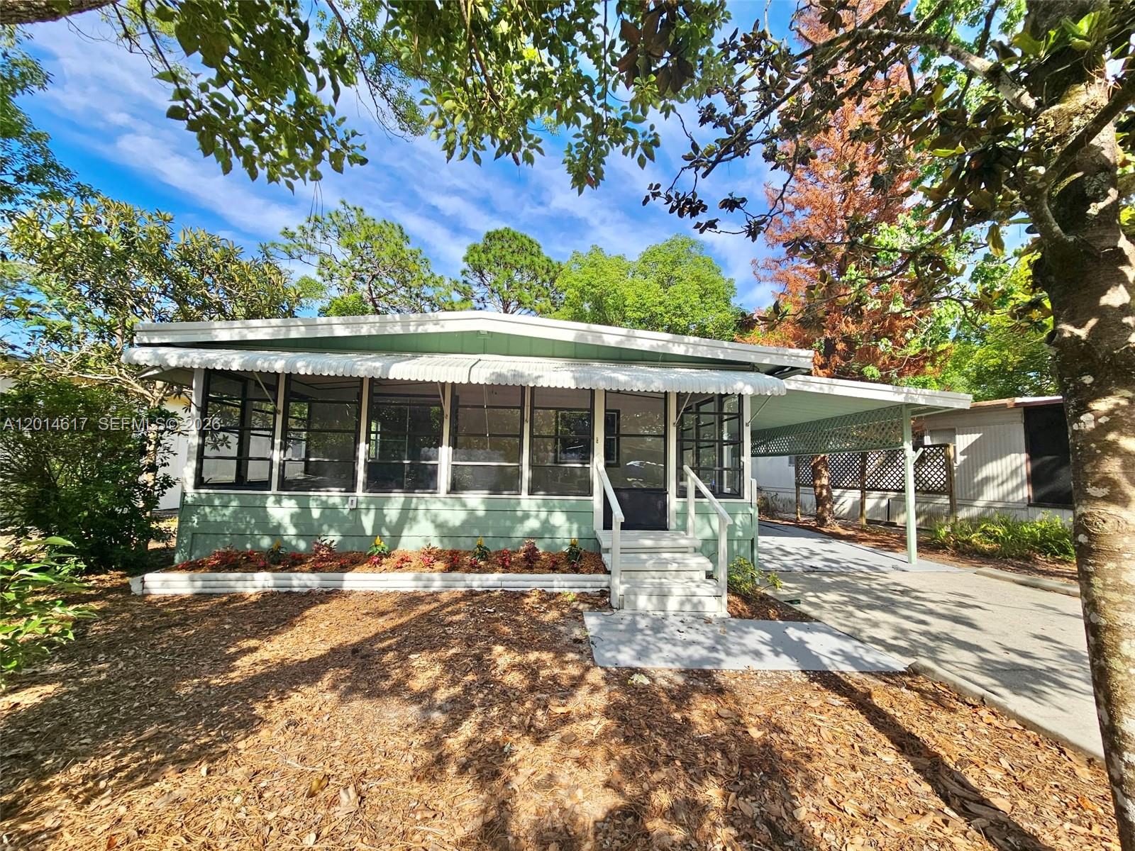 NEW PRICE IMPROVEMENT — REDUCED $5,000!  Stunning move-in ready 2BD/2BA, 1,259 sq ft home in The Forest — Lake Mary's premier gated 55+ community — where YOU OWN YOUR LOT! Fully renovated from top to bottom, this double-wide shines like new. Brand new roof with all-new plywood decking and reinforced framing. Fresh interior and exterior paint throughout — walls, ceilings, closets, doors, and cabinetry. The heart of this home is a beautifully updated kitchen with new stainless refrigerator and microwave, opening into a generous living and dining space where mornings feel easy and evenings feel like home. New fixtures and plumbing upgrades in both baths. New LVP flooring in bathrooms and walk-in closet. New indoor/outdoor porch carpeting. Epoxy-coated carport slab. Updated GFCI outlets inside and out. Resort-style community amenities include two pools, hot tub, saunas, tennis, shuffleboard, billiards, craft room, library, and a packed social calendar. Minutes to I-4, top shopping, dining, and the Seminole Wekiva Trail. Beaches just 45 min away. Don't miss this rare, fully updated gem — schedule your private tour today!
