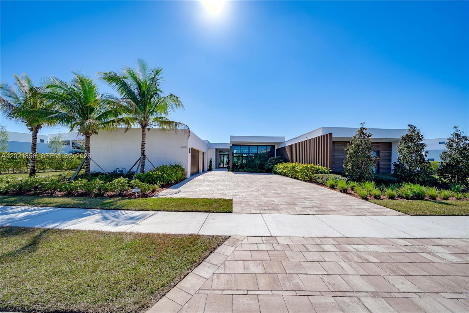Rare Oppenheim O2 Estate on one of Botaniko Weston’s most coveted lakefront lots. Set on 27,127 sqft with breathtaking water views, this one-story modern masterpiece delivers 5,184 sqft of living area, 6 bedrooms, 7.5 baths, and a 3-car detached garage — designed by Chad Oppenheim, FAIA, whose firm has earned over 60 distinctions across 23 countries.
Soaring ceilings, floor-to-ceiling glass, and natural light define every room. The chef’s kitchen features Sub-Zero and Wolf appliances, 42" European cabinetry, and quartz countertops. The primary suite includes a spa bath with Roman tub, bidet, and frameless glass shower. Additional spaces include a private gym, staff quarters, and dedicated office.
The detached 3-car garage is Pre-wired for an electric vehicle charger for added convenience.
Step outside to a fully fenced backyard with heated pool and spa, summer kitchen with built-in grill and icemaker, and lush professional landscaping — all framed by unobstructed lake views. Impact windows and doors throughout.
Weston: rated among the Top 10 Best Places to Live in America. A-rated schools. Minutes to FLL, MIA, and Cleveland Clinic. Cash or conventional financing.