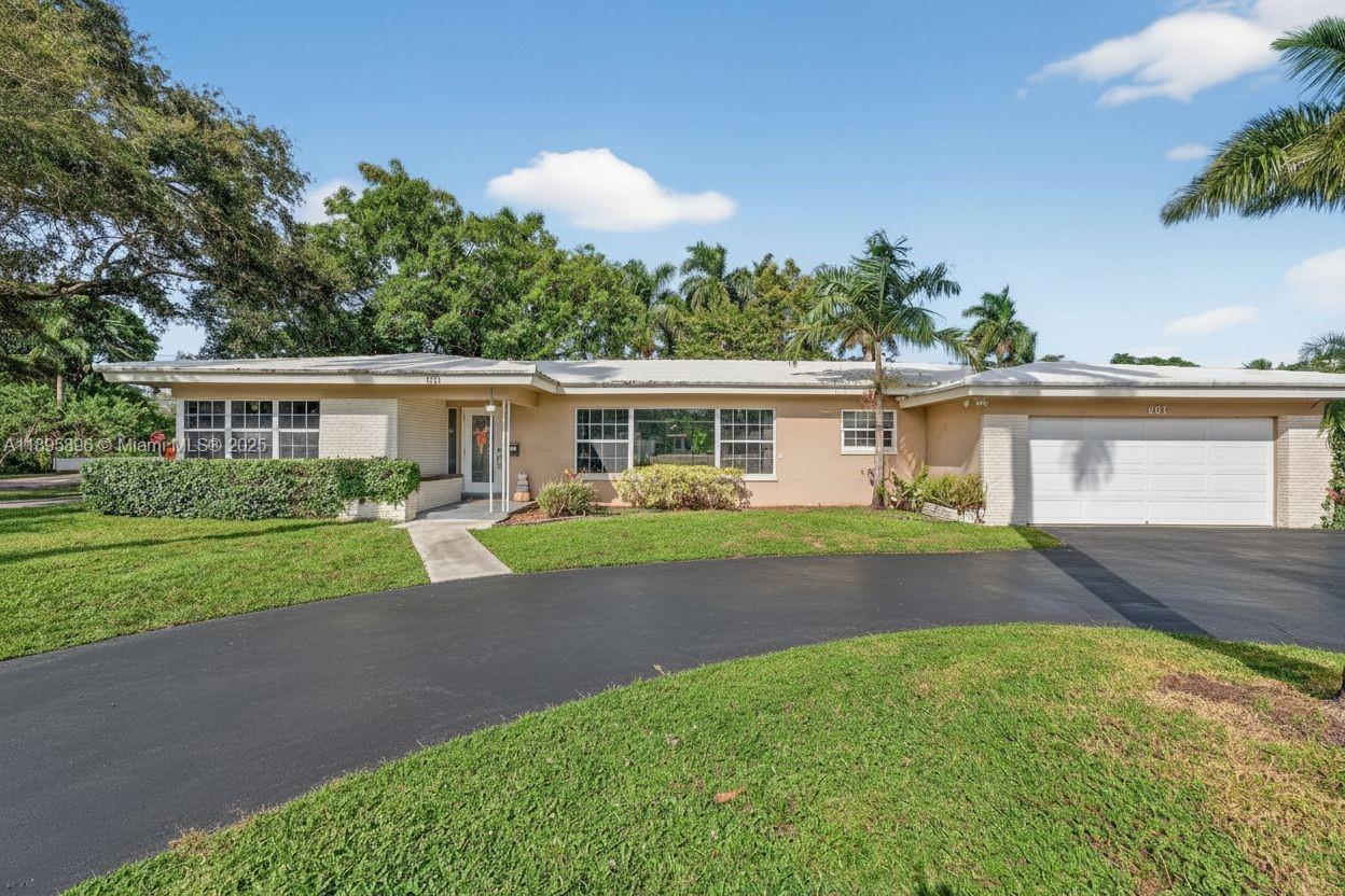 This expansive 4-bedroom, 2-bath Ranch-style estate is gracefully situated on a large corner lot on highly sought-after Holly Lane, offering serene canal views and a private pool oasis. Designed for both comfort and entertaining, the home features a generous open floor plan with a spacious living room and built-in bar, perfect for gatherings. The beautifully updated kitchen and bathrooms blend modern finishes with timeless style, while the oversized bedrooms provide comfort and privacy. This exceptional oversized lot showcases lush, manicured landscaping and a premier Plantation location near everything desired. This is where sophistication meets relaxed South Florida living. **Roof will require replacement; Sellers are willing to provide a credit to assist. Conventional or Cash Offers Only!