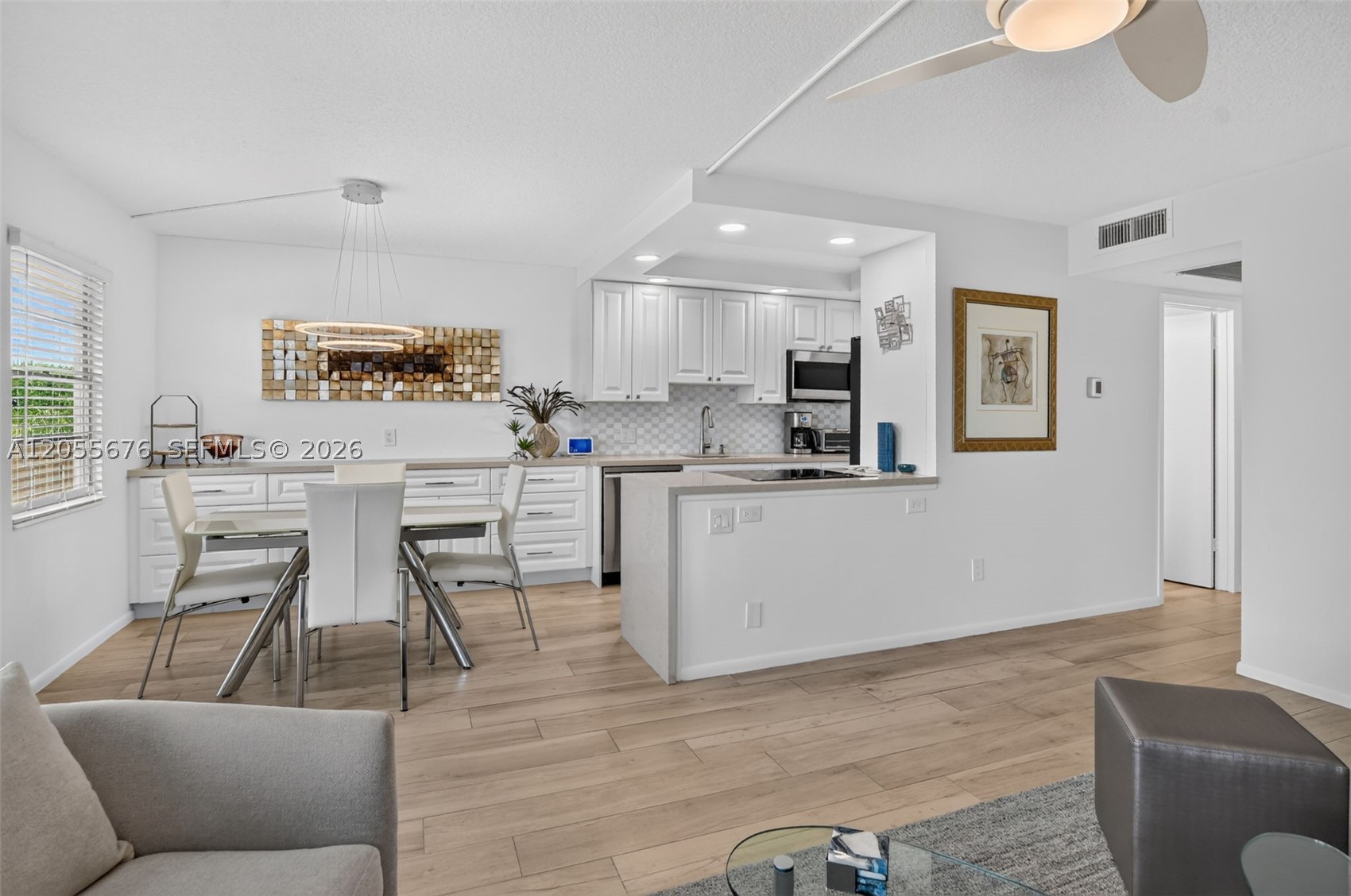 Set in the heart of Century Village, one of Boca Raton's premier active lifestyle communities, this completely reimagined 2-bedroom, 1.5-bath residence offers spectacular lake views and a true gut renovation, taken down to the studs and rebuilt with no detail overlooked. Enclosed sunroom brings sq/ft to 1027 sq/ft using floorplan.

The open-concept kitchen features a suite of high-end stainless steel appliances, custom cabinetry with pull-out storage, a waterfall-edge quartzite countertop, and a designer backsplash under dimmable recessed lighting. New commercial-grade wood-look ceramic tile with soundproofing flows throughout.

The full bath has been rebuilt with a waterfall shower, slow-close glass enclosure, and new vanity, while the half bath has also been fully updated. Both bedrooms offer custom-built closet systems.

The enclosed sunroom showcases the views through impact windows and new French doors. Fresh, smooth ceilings (popcorn removed), new ceiling fans, and dimmable lighting complete every room.

Behind the walls: new electrical panel with surge protection, new water heater, new AC with smart thermostat, keyless entry, and code-compliant smoke detectors — all permitted work.

Century Village offers resort-style living, with an on-site bus system to local shopping and dining, and a community pool just steps from the building. Indoor pool also available.

Luxury finishes, spectacular views, and vibrant community living — nothing left to do but move in.