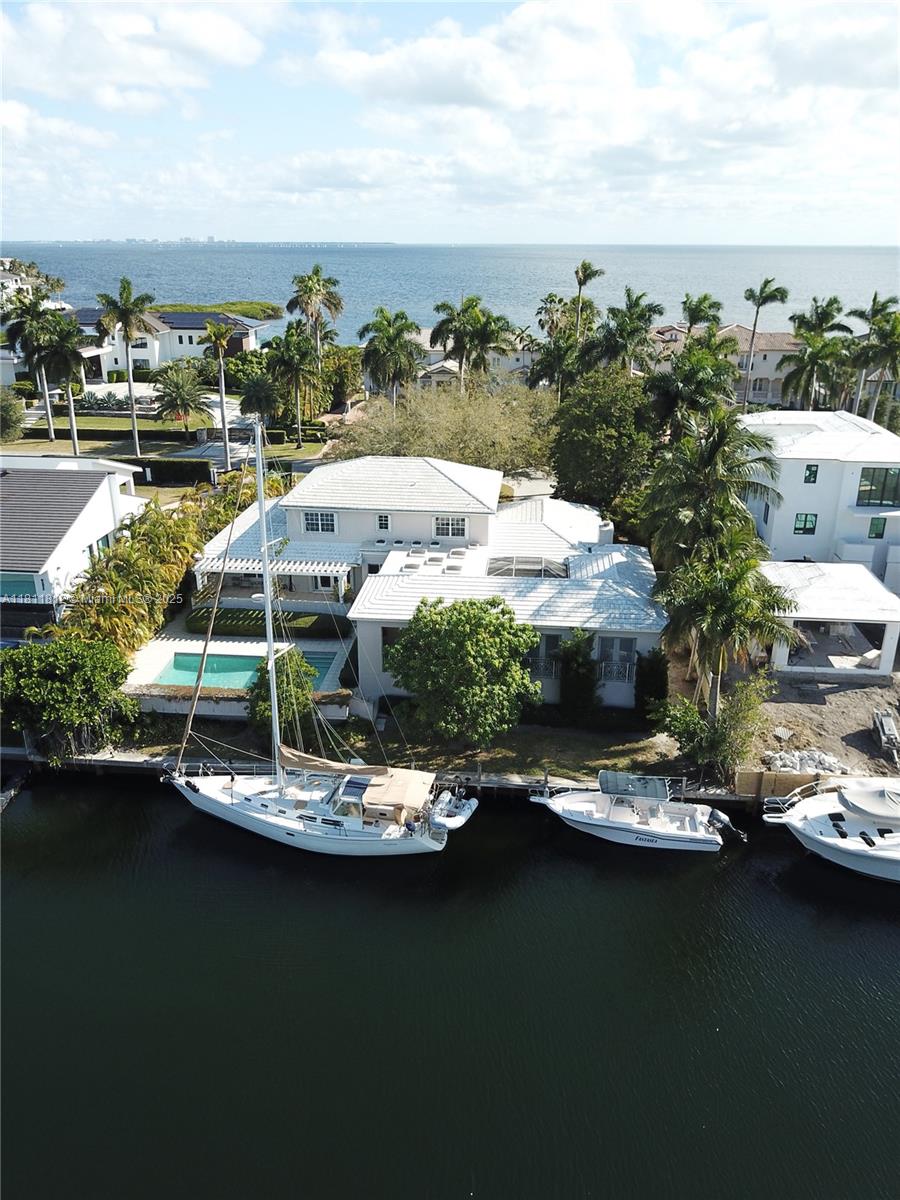 This 6br/5bth property on Mar Street is unique as it sits on a much larger lot than almost all Gables by the Sea homes. With an 18,000+ sf lot, this house is set well back from the street, giving it a stately presence. Inside, the home features a traditional layout with defined living and dining spaces, a spacious well appointed kitchen, and large windows that frame peaceful water views. The main living areas are warm and inviting, ideal for everyday living or entertaining guests. A spacious ground floor master bedroom wing offers an accessible peaceful respite from daily pressures and offers separation and privacy from the rest of the living areas. A screened breezeway leads to the 700 sf apt.  House is 5/4 and apt. is 1/1 incl full kitchen and living room. The home is sold "as is".