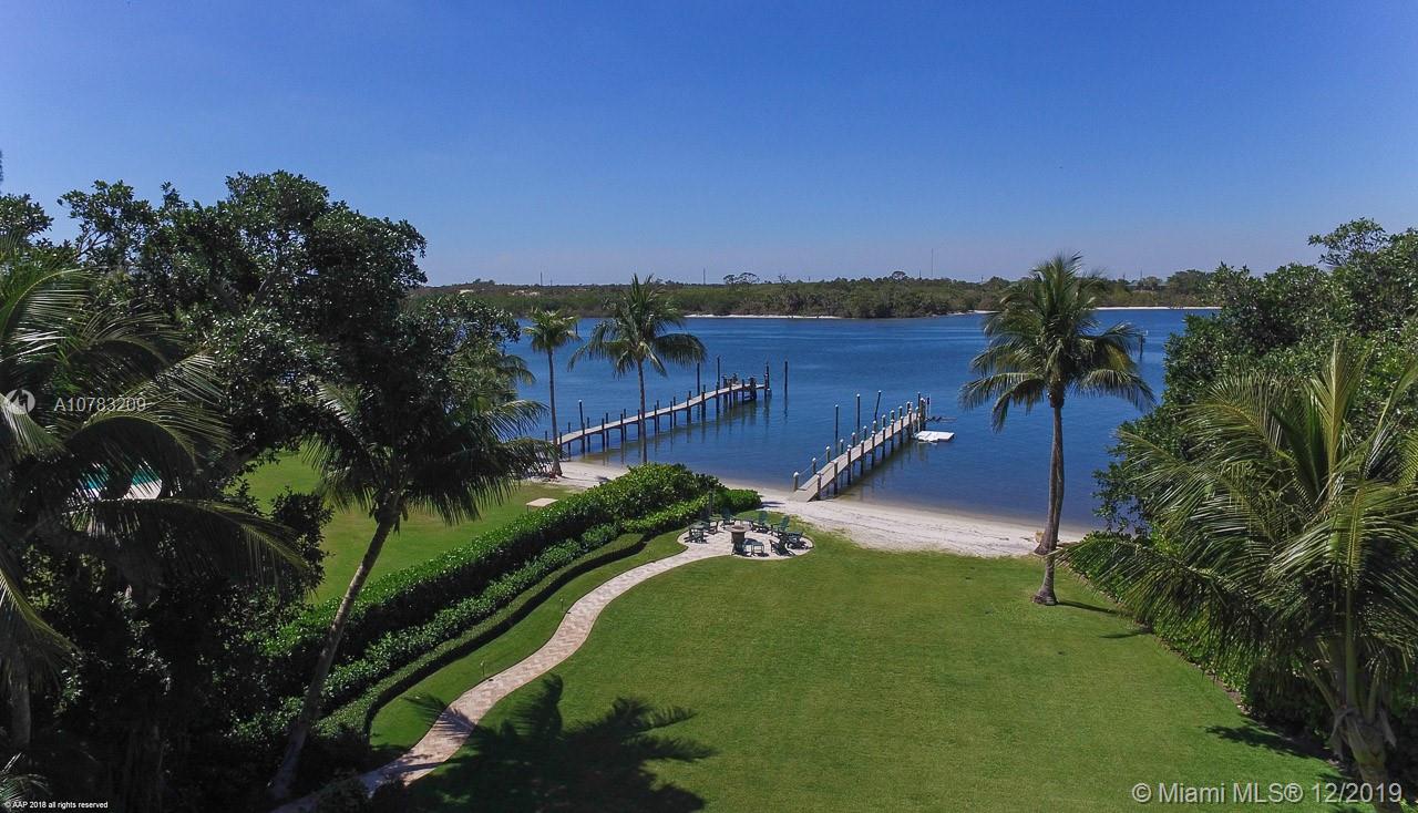 Enter down a long private drive canopied by old growth trees to this magnificent British West Indies 2.6 acre private estate sitting directly on the Intracoastal with sweeping lawns and views across to a natural preserve. Built in 2008, it features outstanding finishes, superb millwork, high ceilings and includes 5 bedrooms with room to expand or build a separate guest house. The kitchen and butler's pantry include top of the line appliances plus there is a family room, game room, climate controlled wine room and first and second floor laundry rooms. Outside, there is a screened outdoor kitchen and dining area in addition to extensive open and covered areas surrounding the infinity edge pool and spa. A curving walkway to a fire pit and dock is surrounded by lush tropical landscaping.