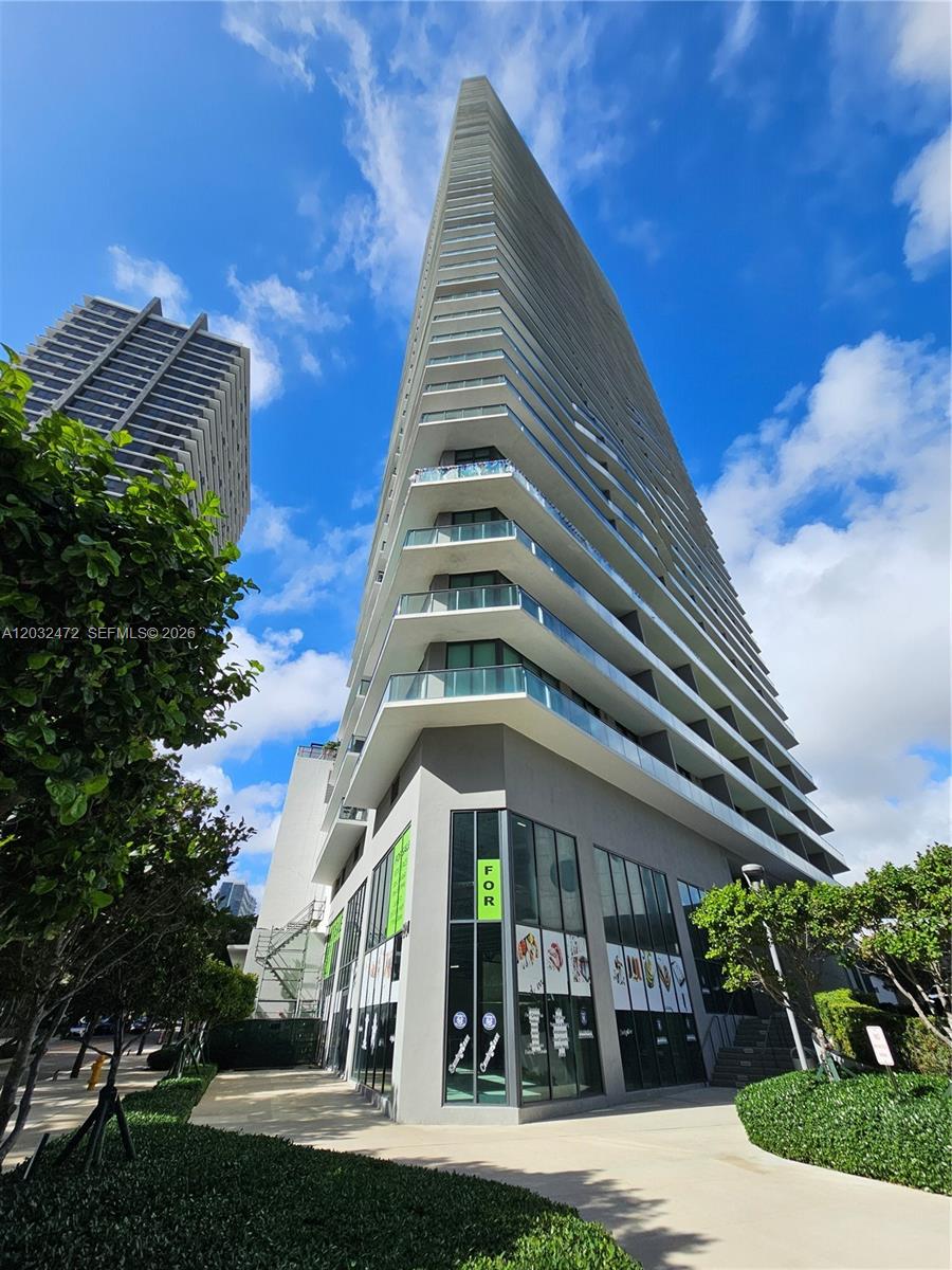 Exceptional opportunity to own a premier two-story commercial space in the heart of Edgewater at Paraiso Bayviews. This unique corner unit offers 7,108 SF across two levels, with 3,554 SF per floor, featuring the largest glass frontages in the building and one of the largest in the area, dramatic double-height exposure, a private elevator, and 11 dedicated parking spaces. Delivered in vanilla box condition, the property provides complete flexibility to customize the space for retail, medical, wellness, office, showroom, educational, restaurant, or professional uses. Located in one of Miami's fastest-growing neighborhoods, the property benefits from outstanding visibility, strong pedestrian and vehicle traffic, and immediate access to Midtown, the Design District, Wynwood, Downtown Miami, and Biscayne Boulevard. Ideal for owner-users seeking a flagship location or investors looking for a high-profile asset with flexible leasing potential. Seller financing available, a rare and highly valuable opportunity. Available as a full two-story commercial unit totaling 7,108 SF.