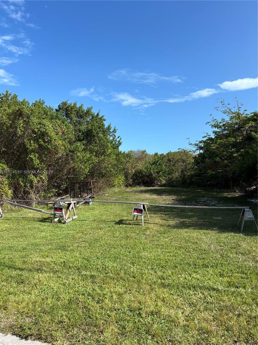 TIER 1 LOT IN A QUIET NEIGHBORHOOD ON A DEAD END STREET. POWER, WATER, SEWER IN FRONT OF LOT, SURVEYED, CURRENTLY FLOOD ZONE AE-8, MOSTLY CLEARED AND FILLED, CURRENTLY USED FOR STORAGE, NO PERMITS, COULD BE WORTH ROGO POINTS, COUNTY OWNS LAND NEXT TO AND BEHIND LOT MAKING IT UNLIKELY TO BE DEVELOPED. FLEXIBLE PRICE, BUYER TO VERIFY ALL INFORMATION, MAKE AN OFFER OWNER AGENT