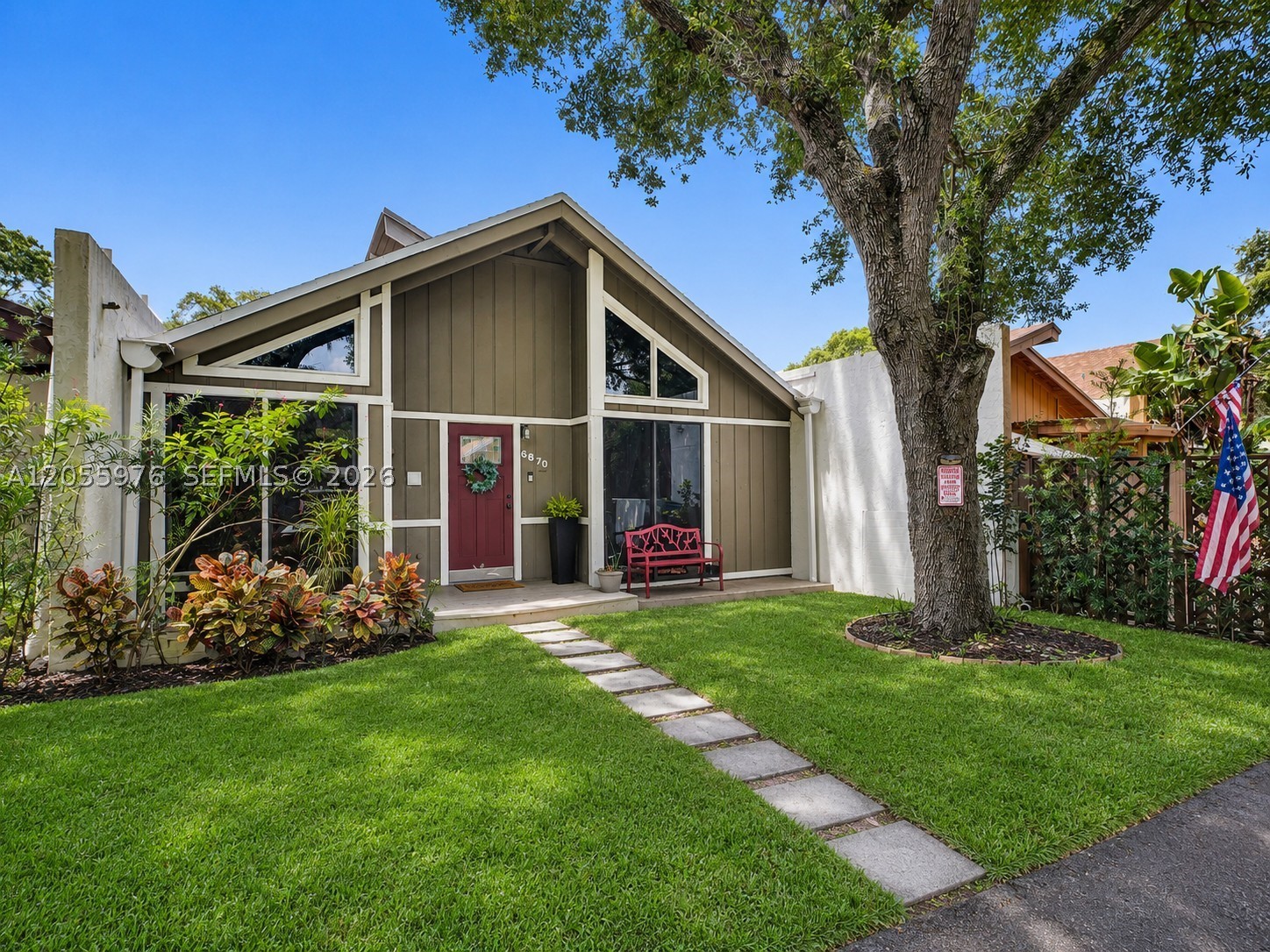 Welcome to 6870 NW 30th Ave, where nature-inspired architecture, walls of glass and natural light create a warm, unforgettable setting. Shed dormer windows brighten the loft, etched-glass sliders enhance the primary bedroom, and a rare sunken conversation pit anchors the living room. Floor-to-ceiling windows frame the South Florida sky, letting you drift off beneath the full moon or watch sunsets fill the home with color. Expansive sliders connect indoor and outdoor living for memorable evenings with family and friends. $35/mo HOA!
The open layout features a renovated kitchen, updated baths with dual-flush toilets, tile flooring, updated lighting and hardware, walk-in closets, plus a den with its own half bath and closet. Outside: fenced backyard, storage shed, two-car driveway and access to an HOA-maintained gated park.
Major updates: shingle roof Nov. 2020; full rewiring in 2020 with new panel and master shutoff; new plumbing lines; impact windows and door in 2025; tankless water heater in 2018; professionally maintained 2017 HVAC; kitchen appliances replaced in 2020, including Samsung Smart energy-efficient front-load washer and dryer; and preventative subterranean termite treatment in 2020, with documentation and warranty available. Accordion and aluminum-panel shutters provide added hurricane protection.
Centrally located on a quiet dead-end street near Inter Miami’s stadium, I-95, Fl Turnpike, Fort Lauderdale Executive Airport, shopping, dining and entertainment.